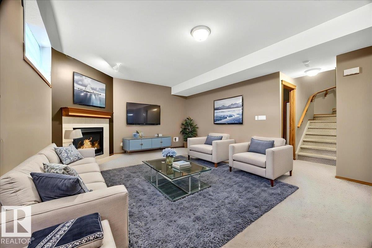 Living area featuring a fireplace with a wood mantle, a built-in media console, recessed lighting, and carpeted flooring - 11824 13 Avenue, Edmonton, AB - Indoor Photo Showing Living Room With Fireplace
