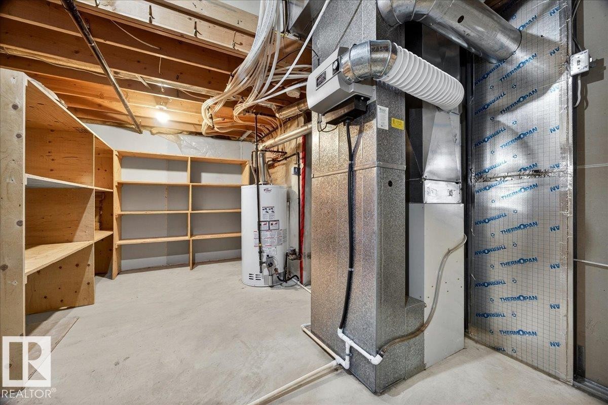 Unfinished basement with concrete flooring and exposed ceiling joists - 11824 13 Avenue, Edmonton, AB - Indoor Photo Showing Basement