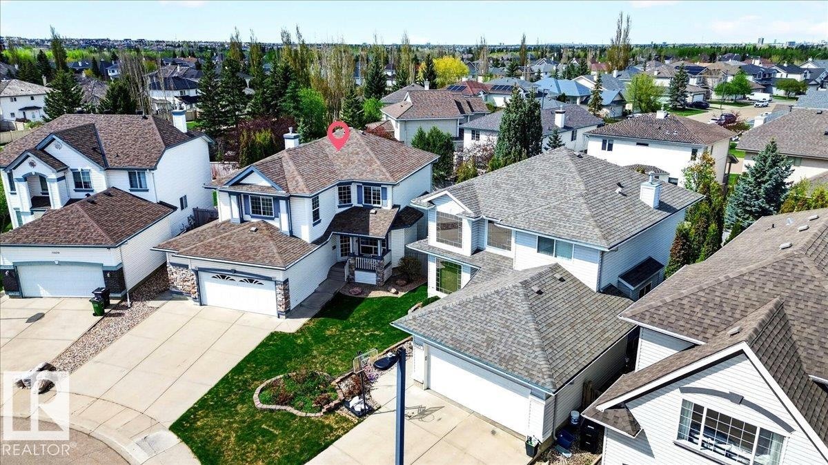 White two-story residence with a brown shingle roof and an attached two-car garage - 11824 13 Avenue, Edmonton, AB - Outdoor