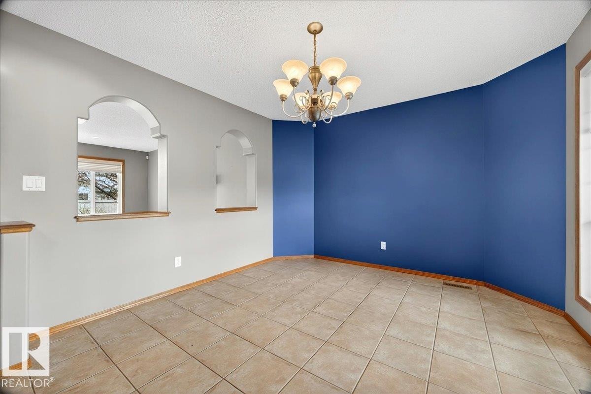 Room featuring tile flooring and a multi-light chandelier - 11824 13 Avenue, Edmonton, AB - Indoor Photo Showing Other Room