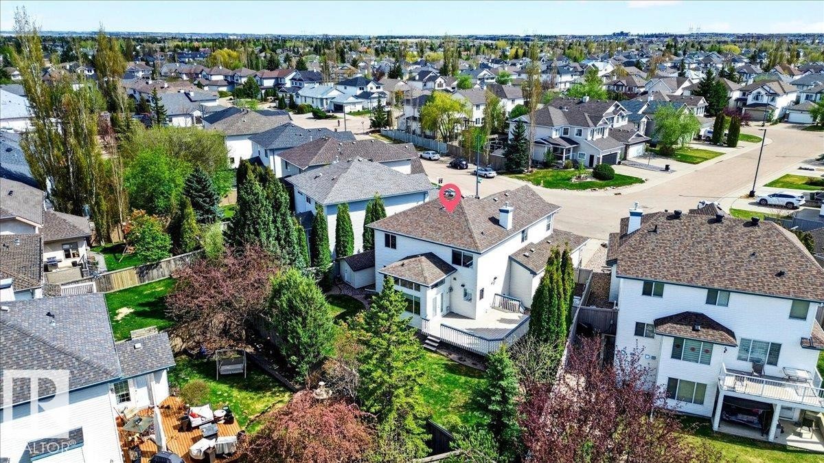 Aerial perspective showcasing a residential property with a multi-level deck, mature landscaping, and a fenced backyard - 11824 13 Avenue, Edmonton, AB - Outdoor
