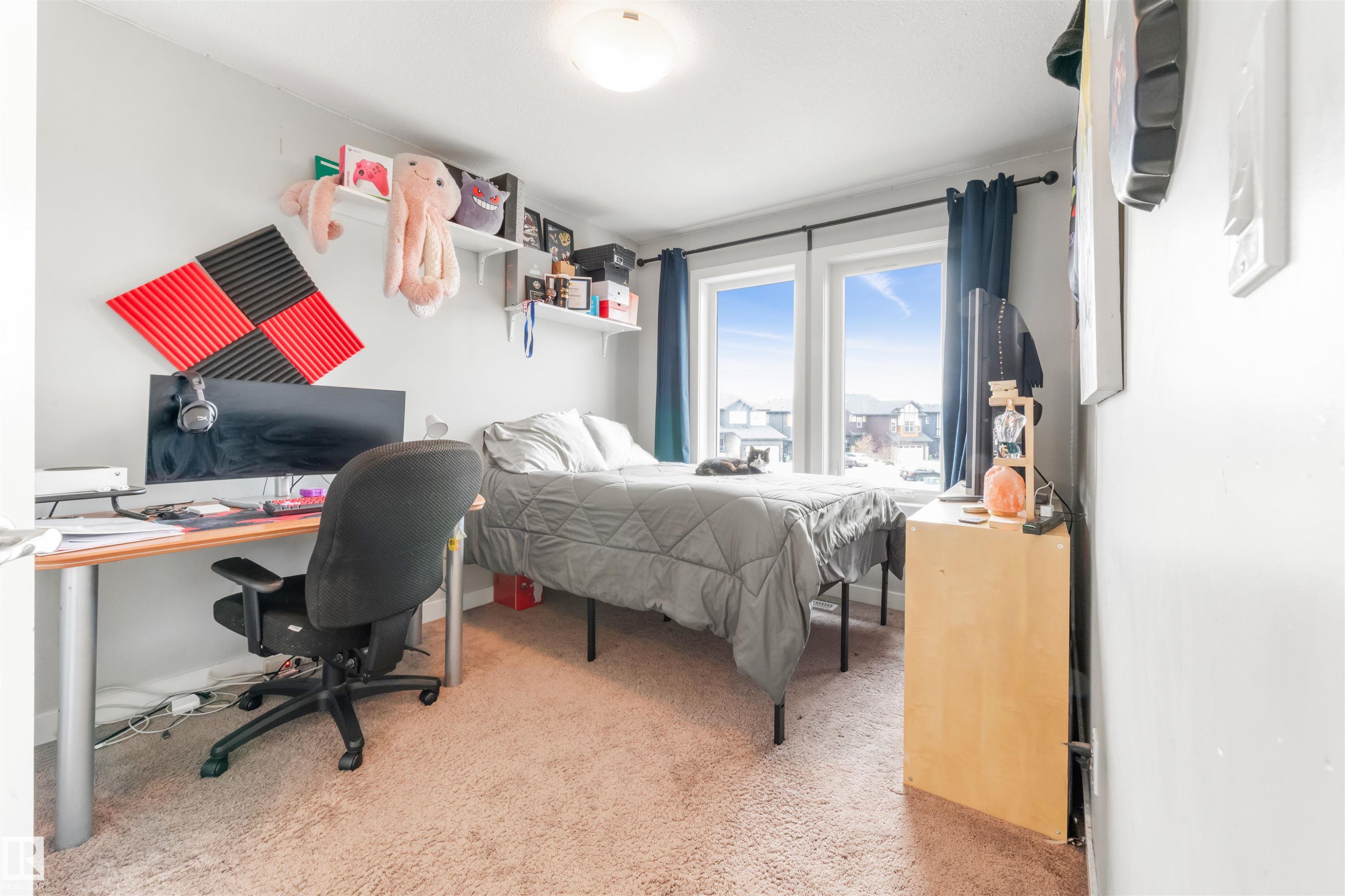 This room features light-colored walls, carpeted flooring, and a large window providing natural light - 607 40 Street Sw, Edmonton, AB - Indoor Photo Showing Bedroom