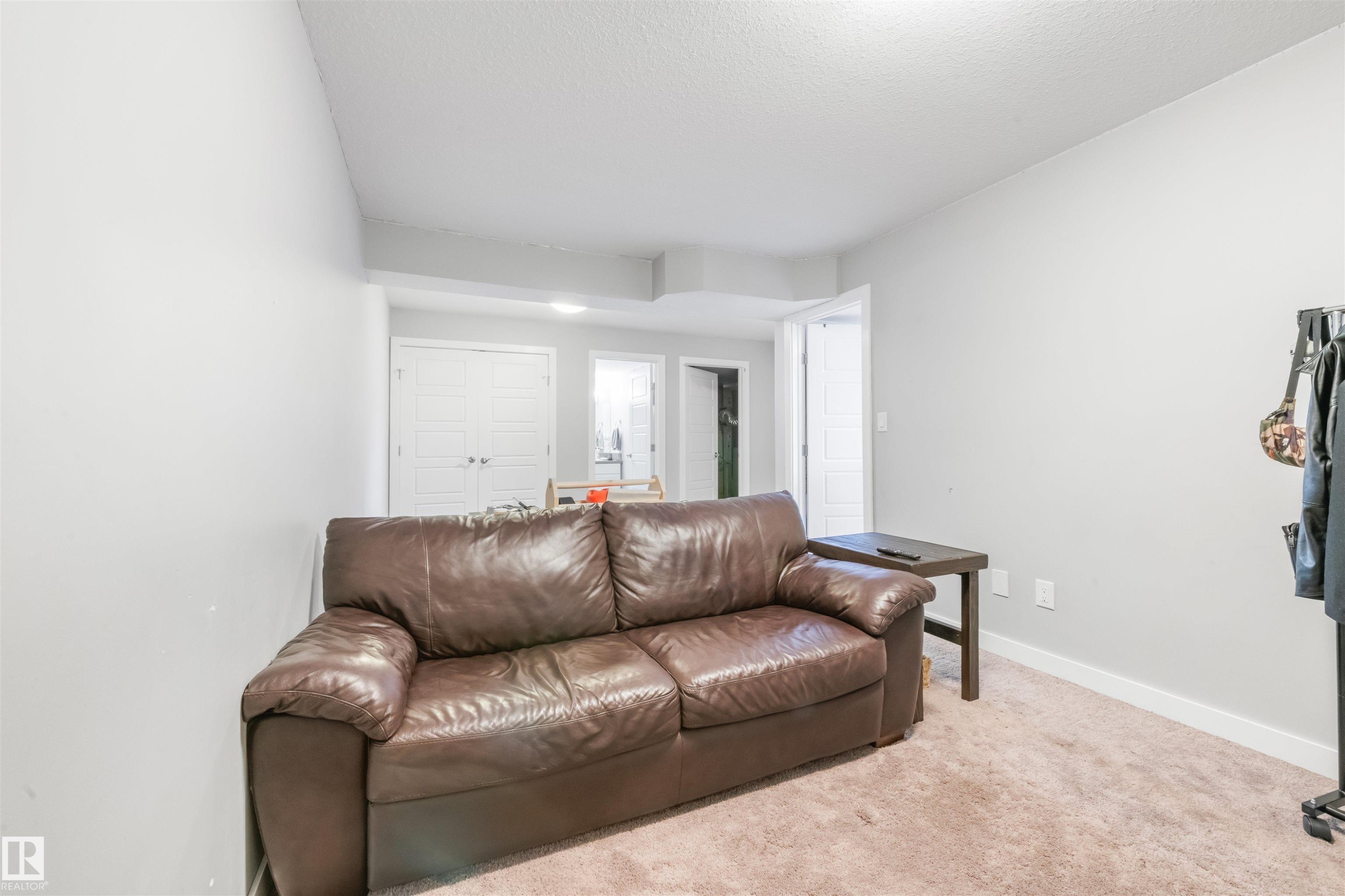 Living area featuring light gray walls, recessed lighting, and carpeting - 607 40 Street Sw, Edmonton, AB - Indoor Photo Showing Living Room