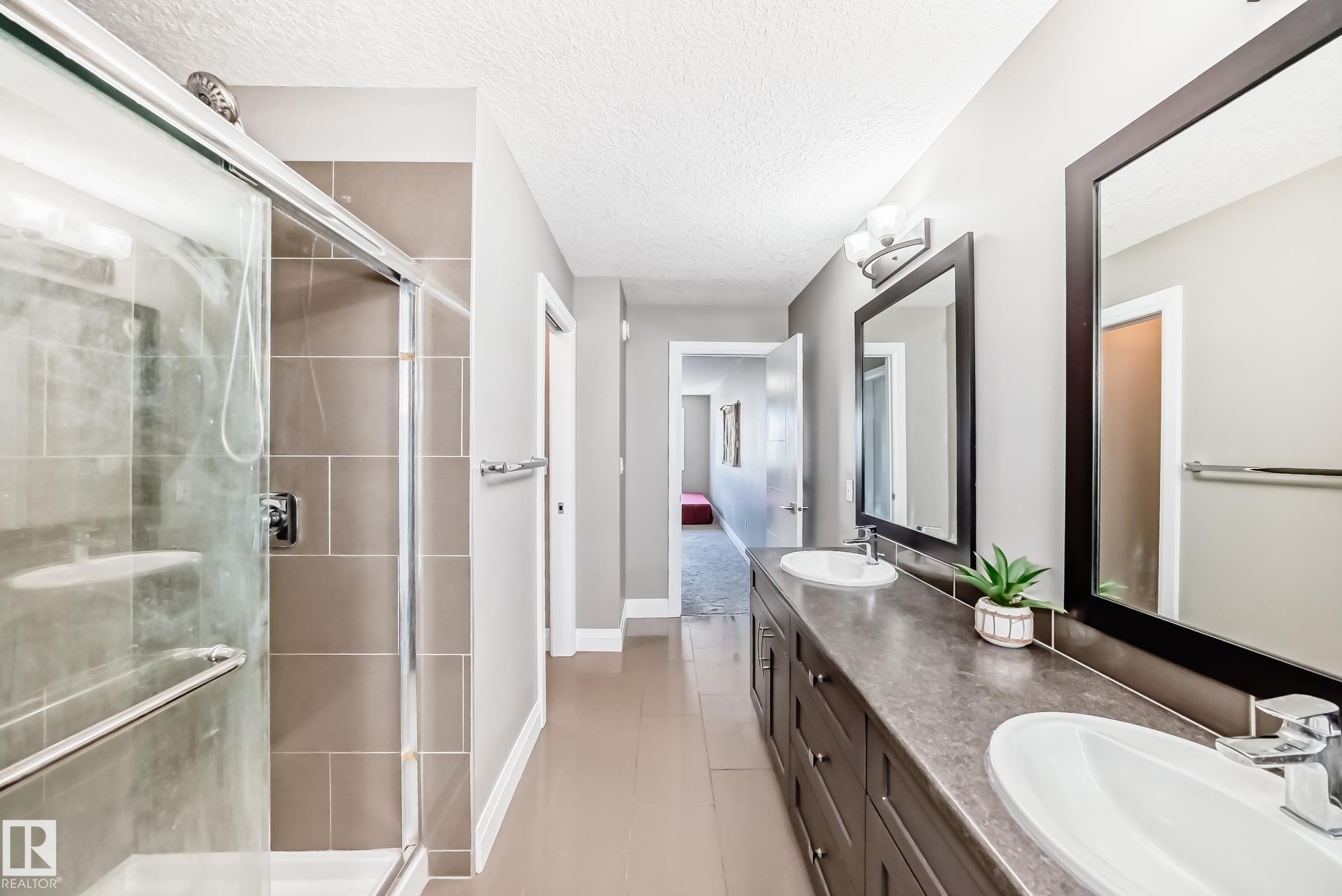 Double vanity with dark wood-finish cabinetry and rectangular undermount sinks - 4155 Charles Link, Edmonton, AB - Indoor Photo Showing Bathroom