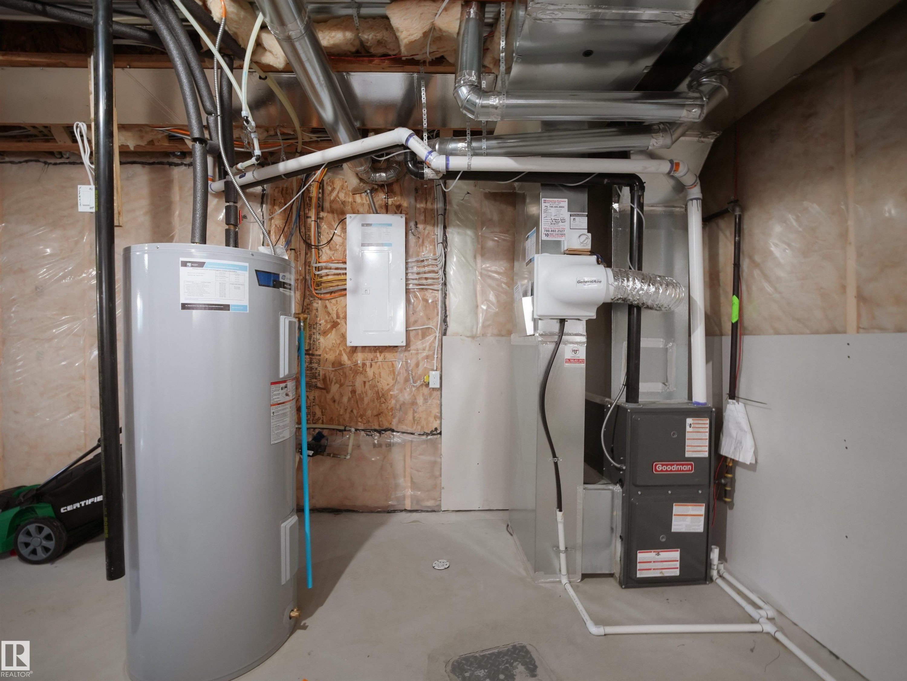 Utility area featuring a water heater, furnace, and exposed ductwork - 30 Hope Cm, Spruce Grove, AB - Indoor Photo Showing Basement