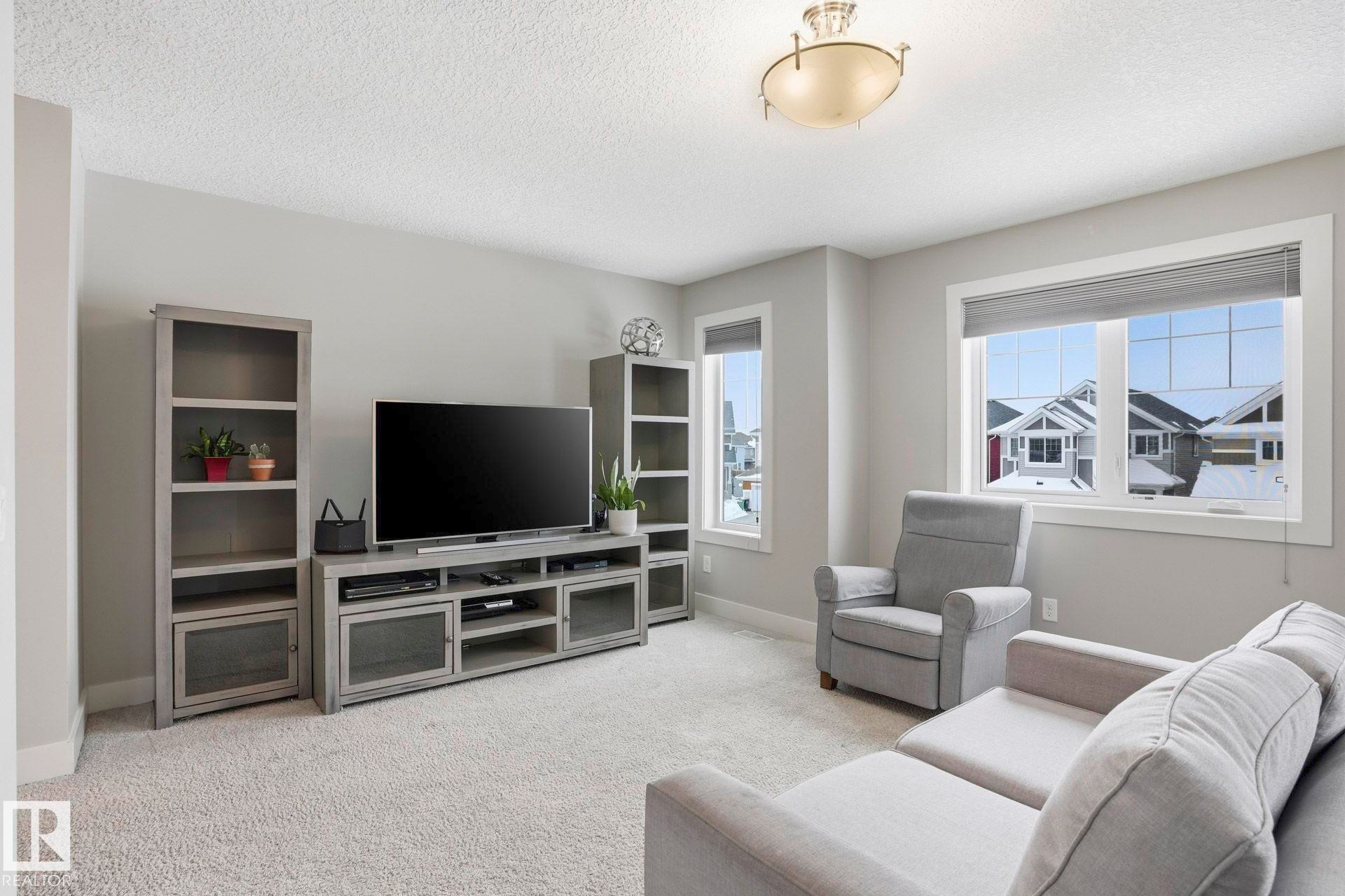 Living room with light carpet and a textured ceiling - 1915 77 Street, Edmonton, AB - Indoor Photo Showing Living Room