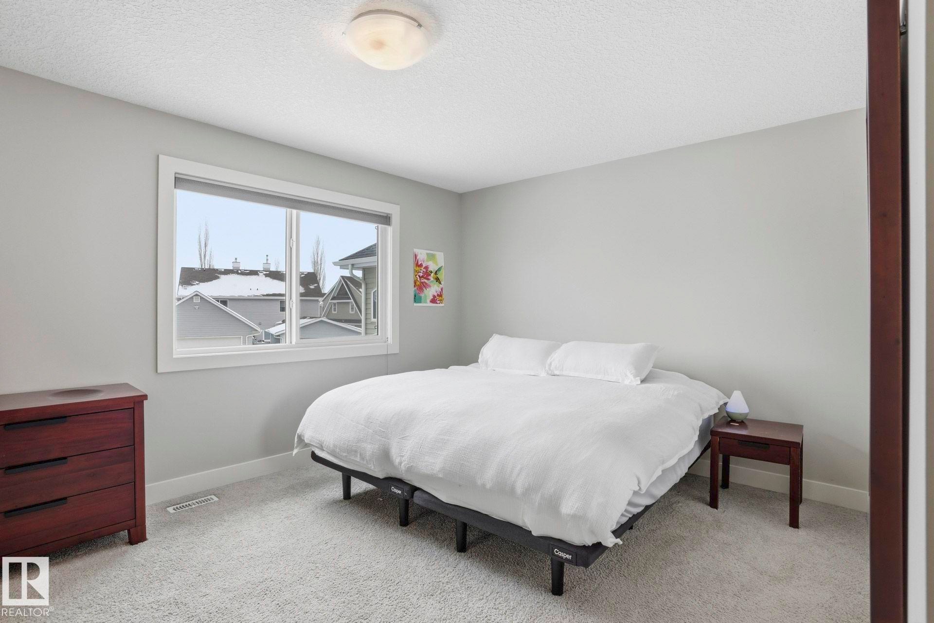 Bedroom featuring light colored carpet and a textured ceiling - 1915 77 Street, Edmonton, AB - Indoor Photo Showing Bedroom