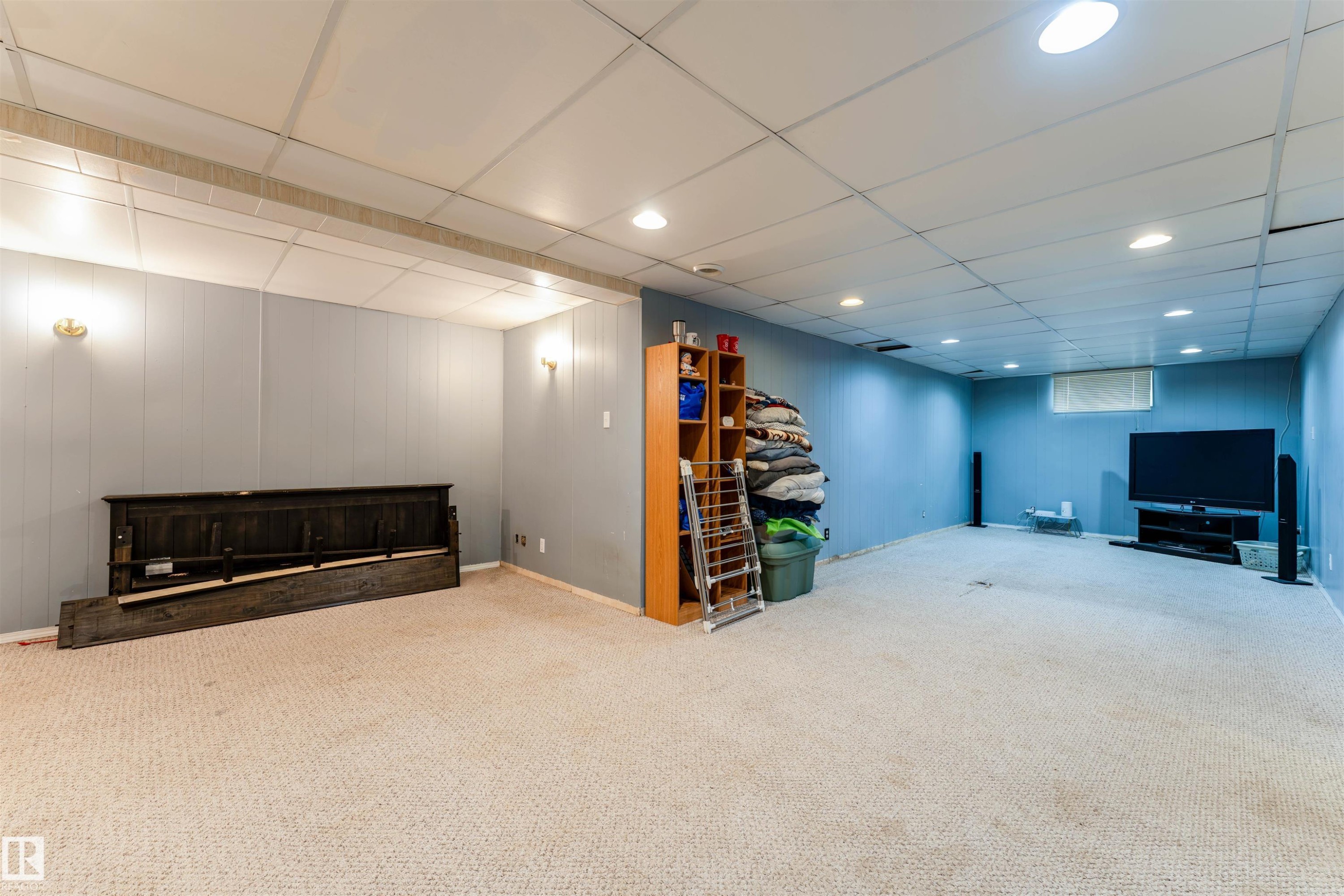 Spacious finished lower level featuring recessed lighting and wall sconces - 13231 74 Street, Edmonton, AB - Indoor Photo Showing Basement