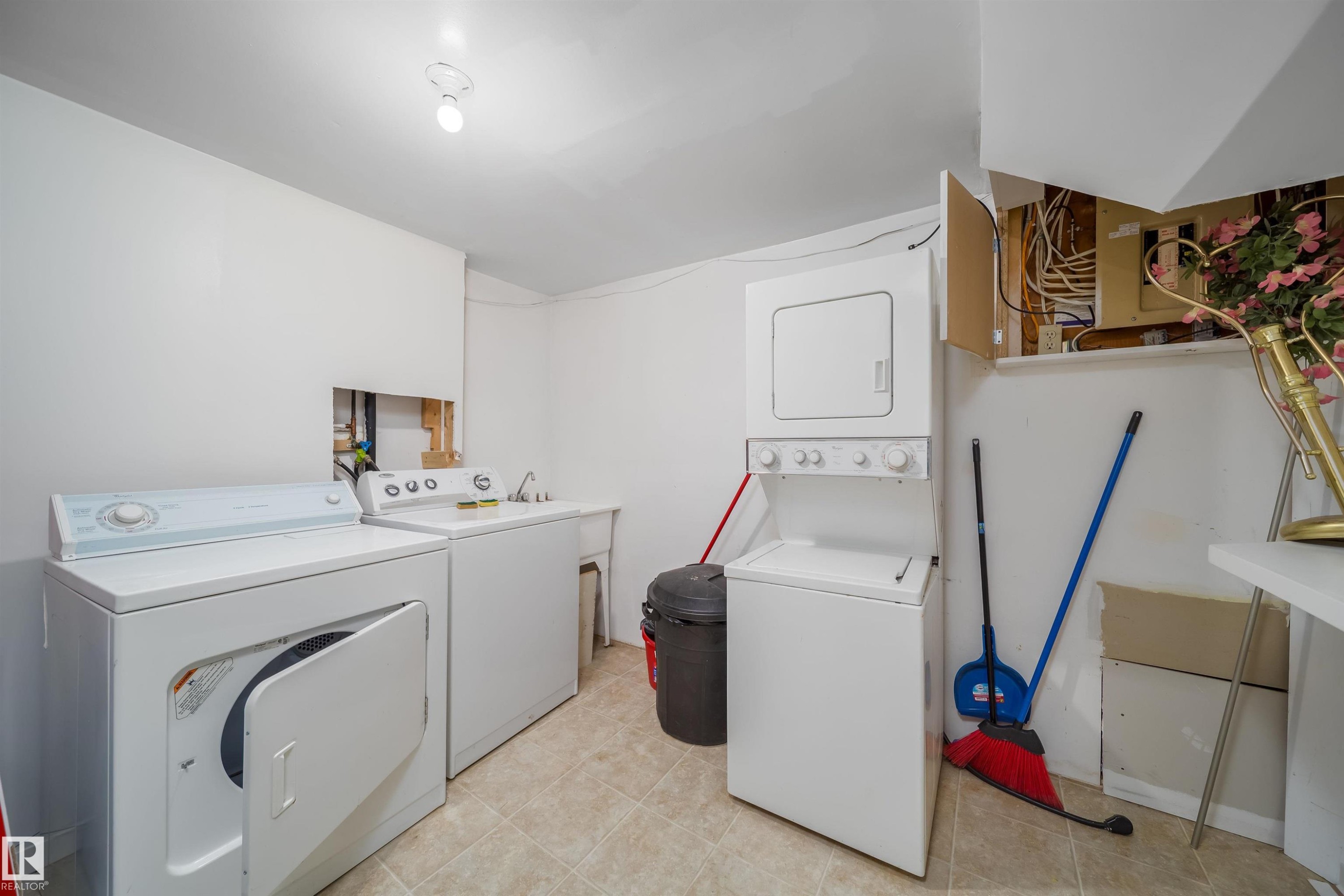 Dedicated laundry area featuring tile flooring, white walls, and a utility sink - 1771 37 Street, Edmonton, AB - Indoor Photo Showing Laundry Room