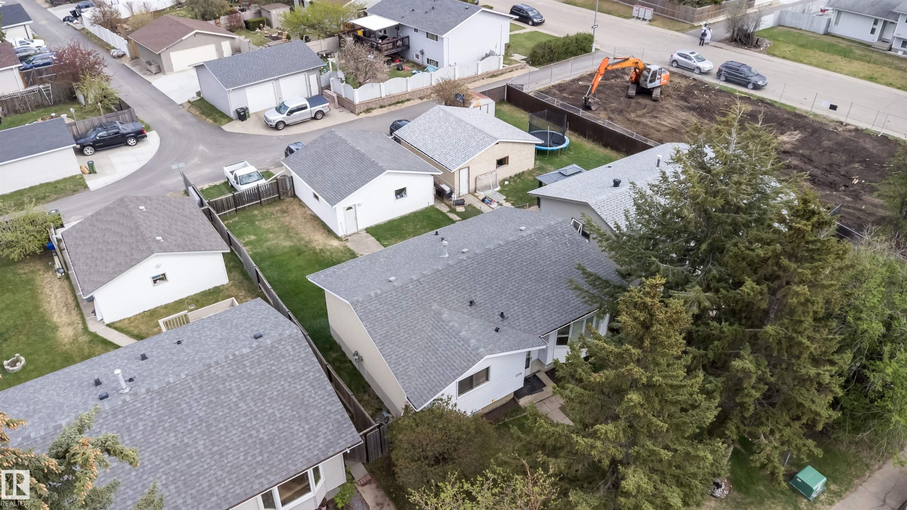 Aerial view highlighting the property with a gray shingle roof, surrounded by mature evergreen trees - 1771 37 Street, Edmonton, AB - Outdoor With View