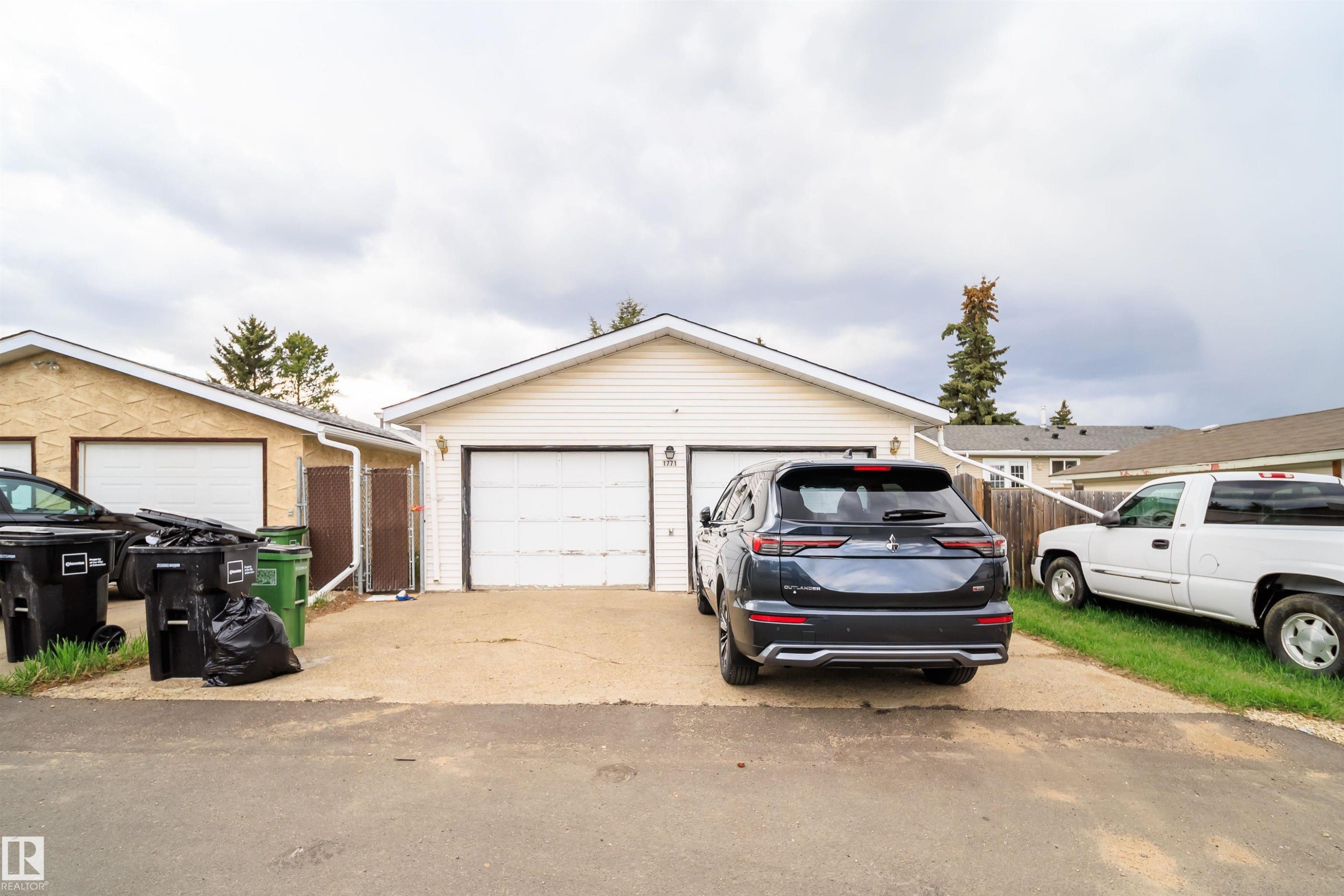 Two-car detached garage with white panel doors and light-colored siding - 1771 37 Street, Edmonton, AB - Outdoor