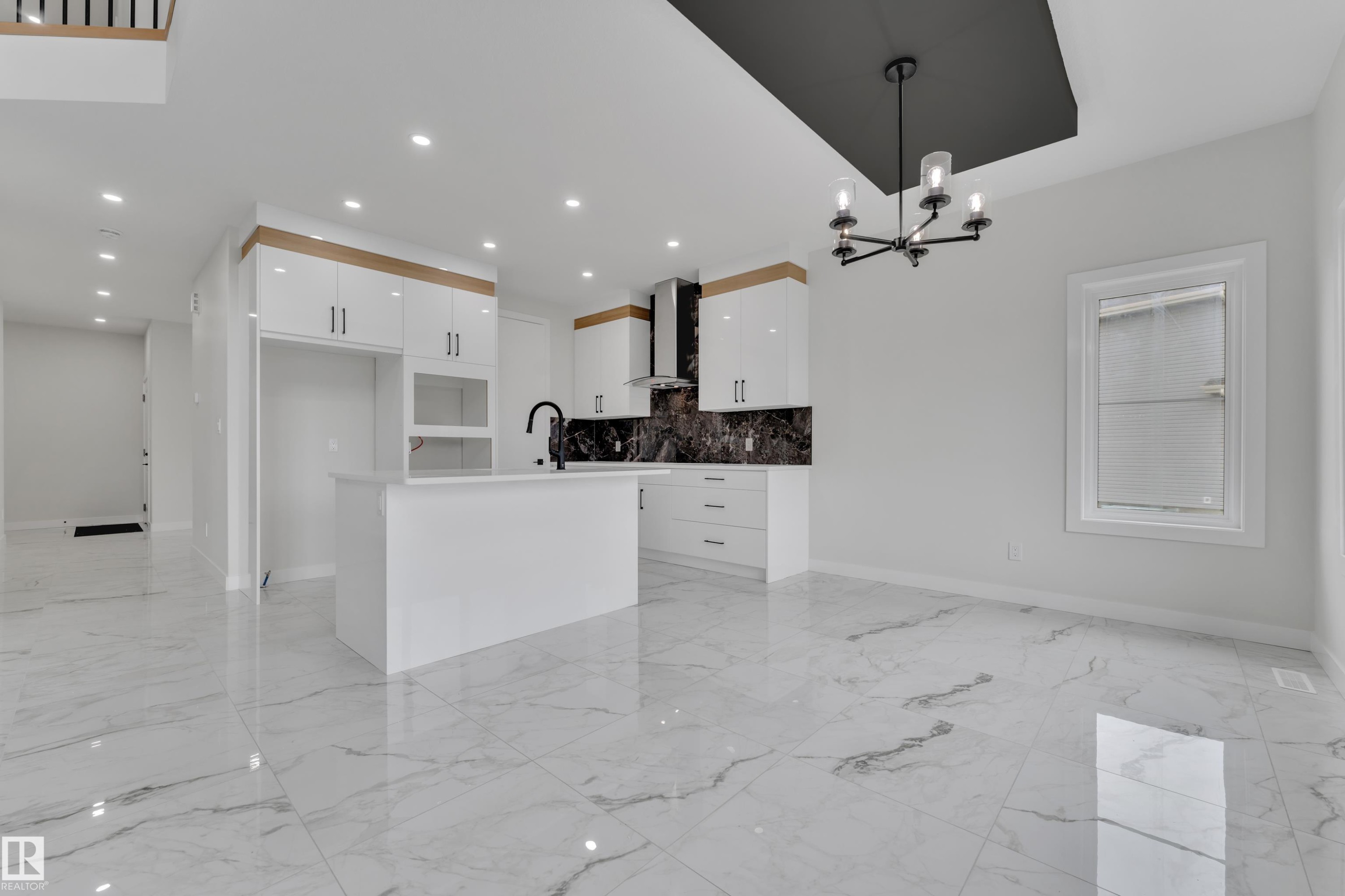 Open-concept kitchen and dining area featuring large format marble-look tile flooring - 12623 44 Street, Edmonton, AB