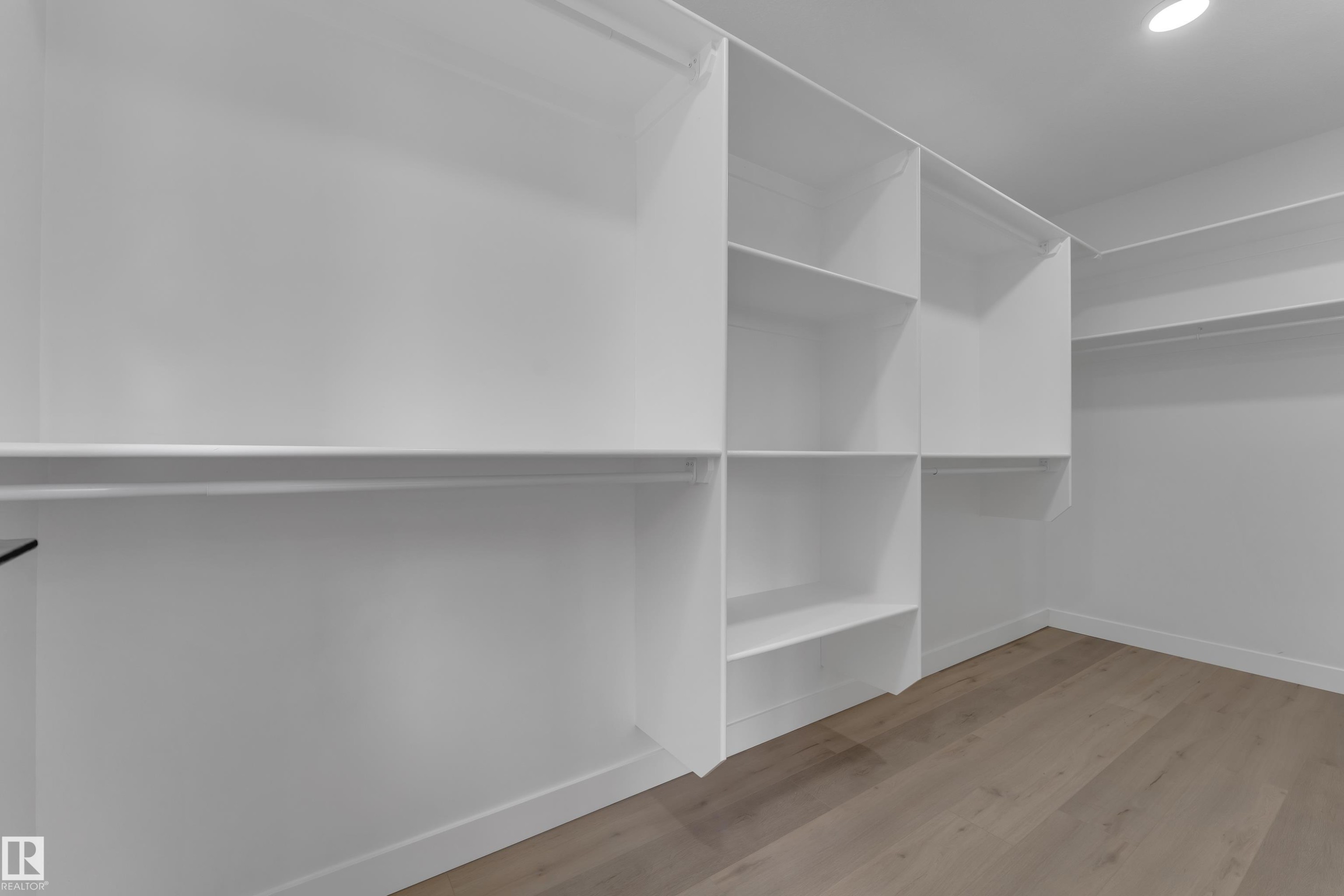 Custom closet system featuring multiple shelves and hanging rods - 12623 44 Street, Edmonton, AB