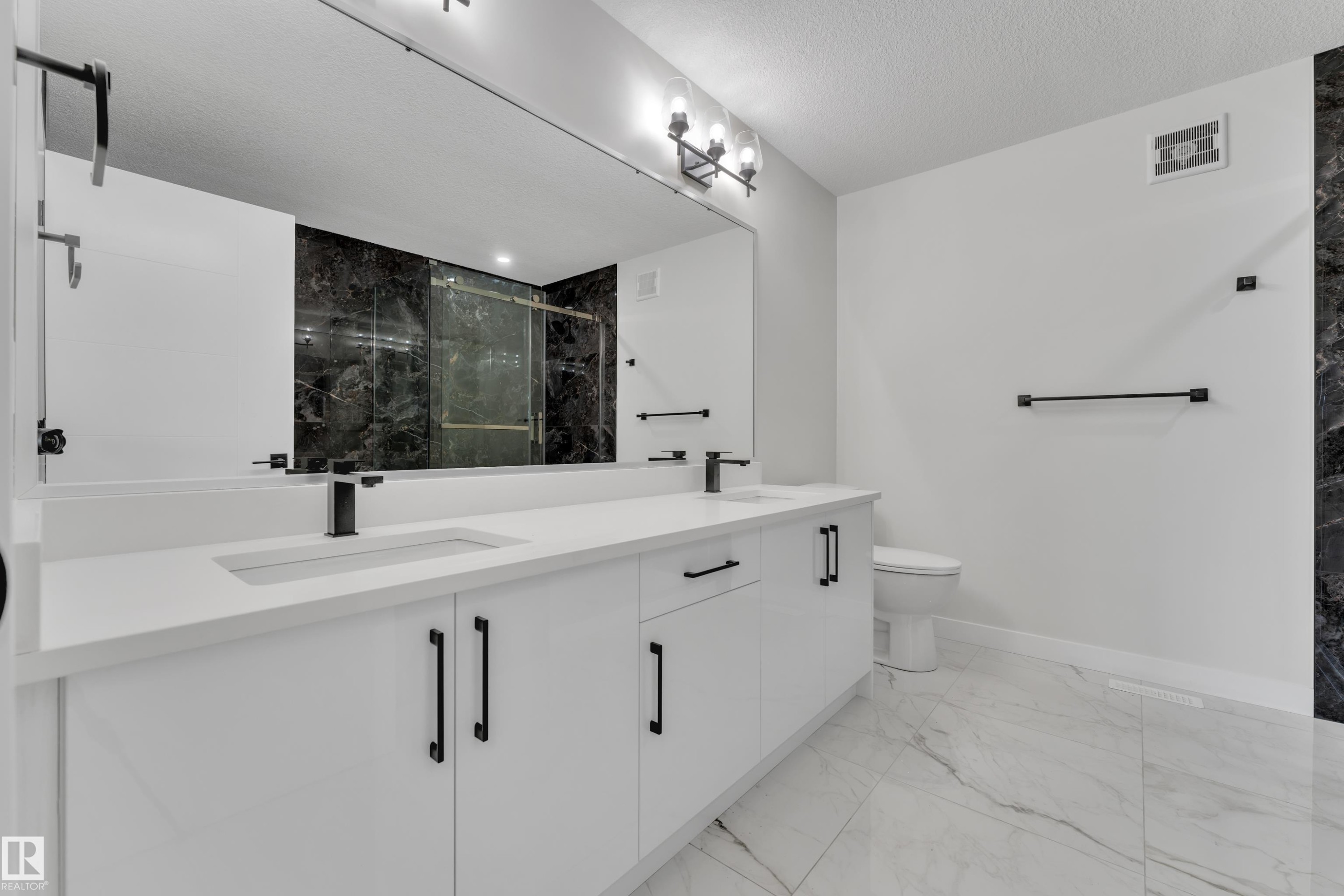 Contemporary bathroom featuring a dual-sink vanity with white cabinetry and matte black hardware - 12623 44 Street, Edmonton, AB