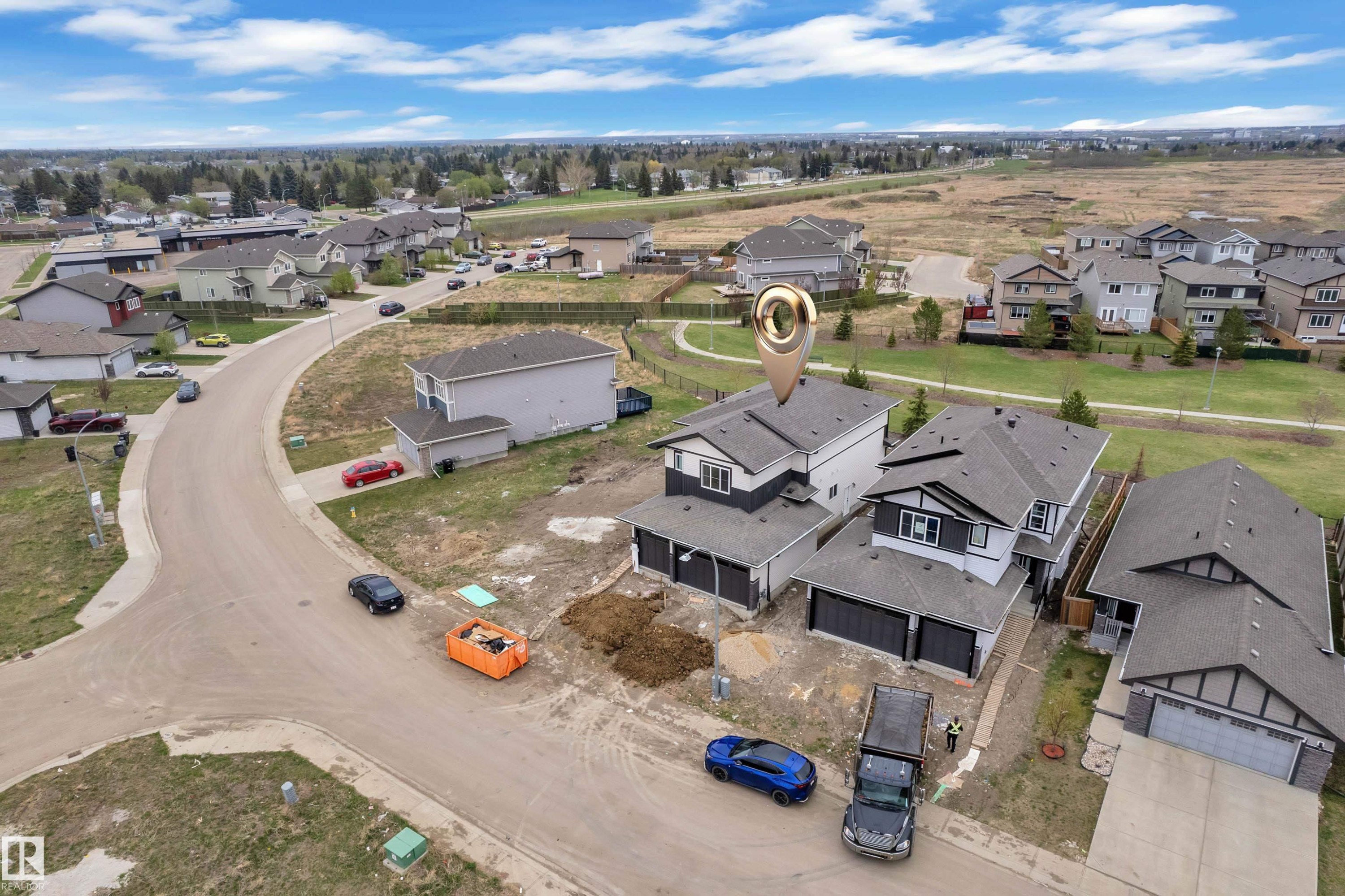 Modern two-story residence with a multi-car garage, dark trim accents, and a light-colored exterior siding - 12623 44 Street, Edmonton, AB