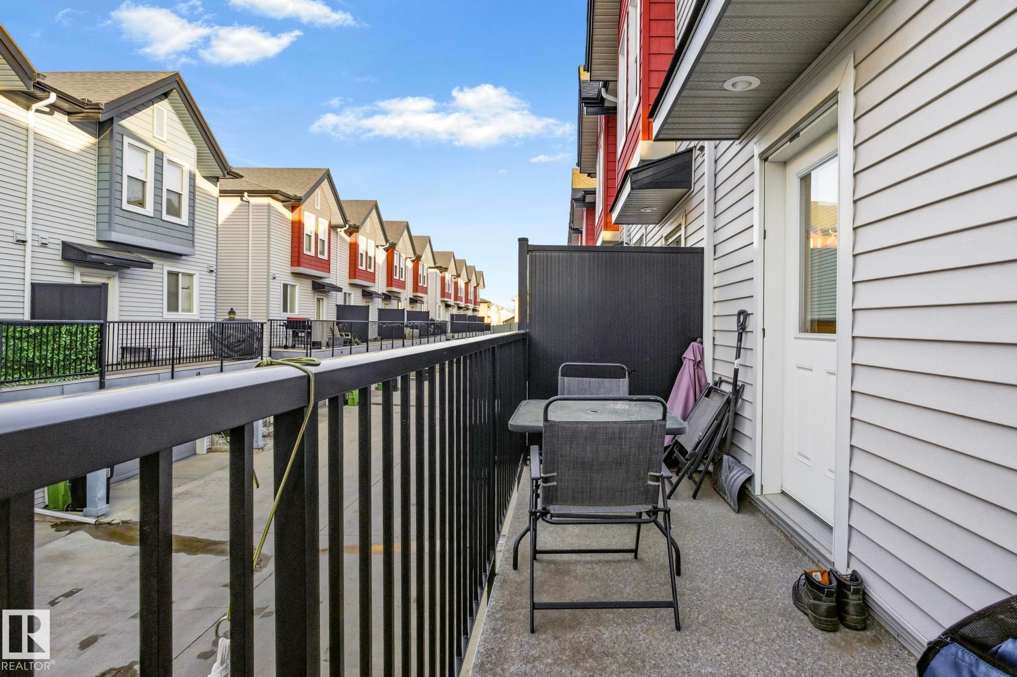 Private balcony patio featuring concrete flooring and a dark metal railing - 30 6075 Schonsee Way, Edmonton, AB - Outdoor With Exterior