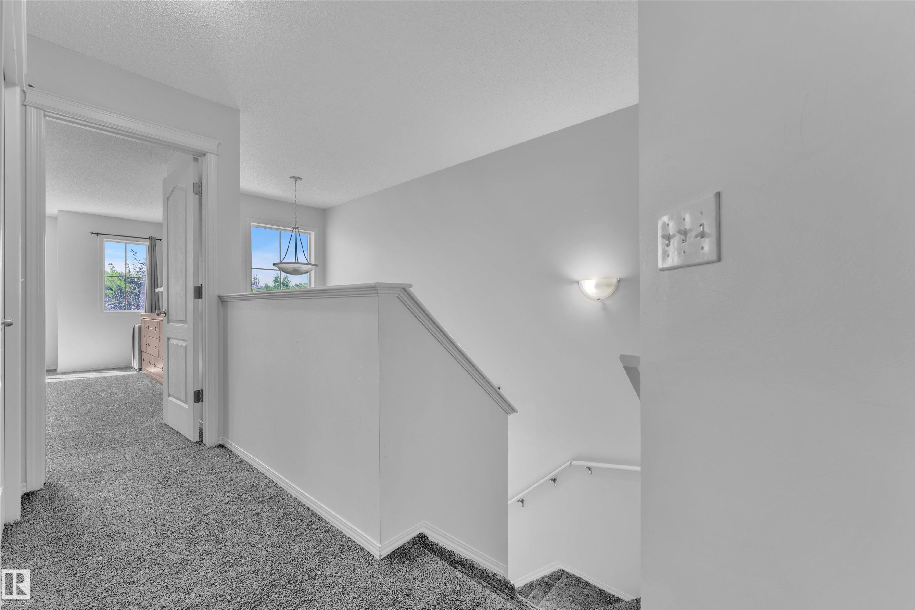 Corridor featuring carpet floors and an upstairs landing - 6152 13 Avenue, Edmonton, AB - Indoor Photo Showing Other Room