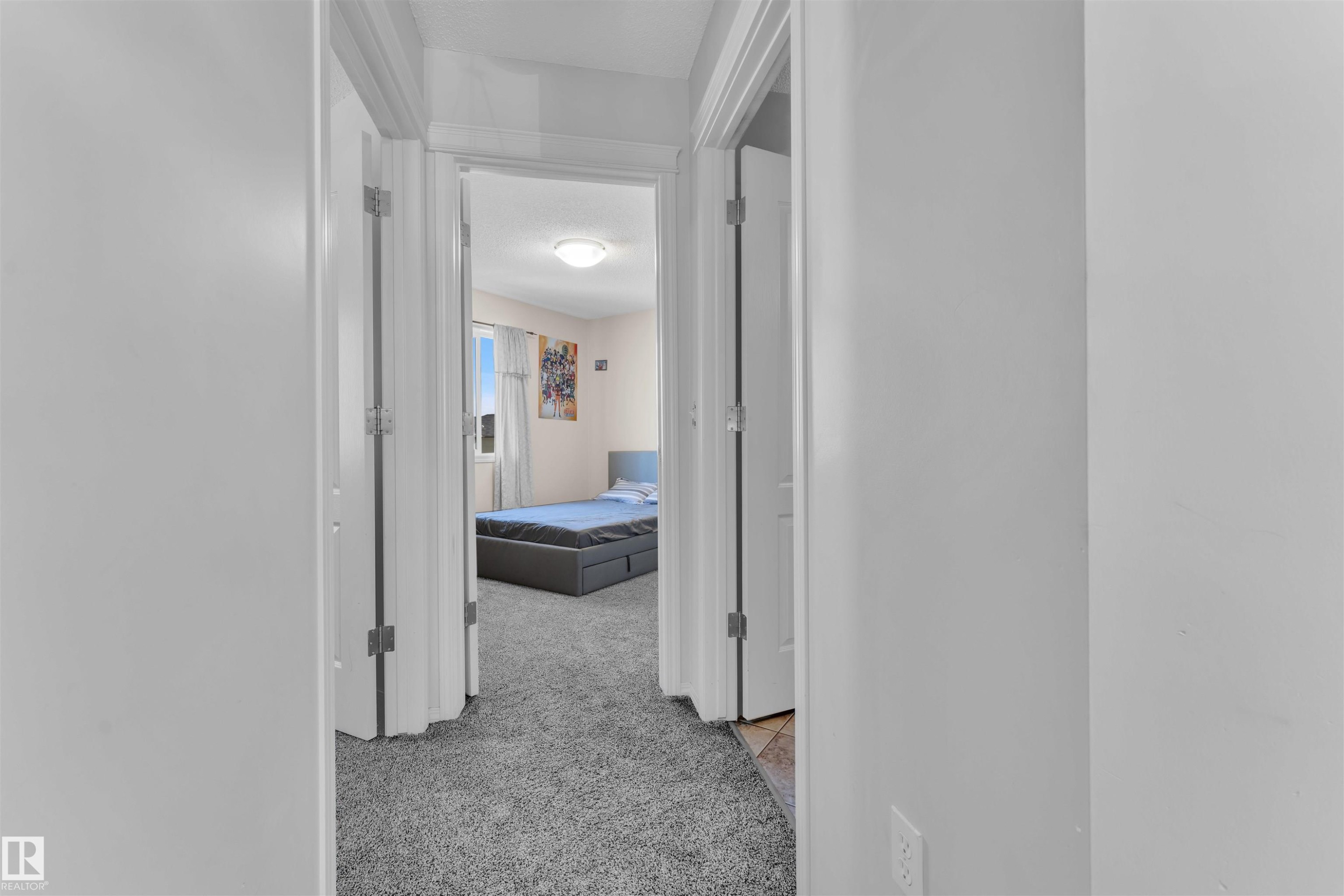 Hall featuring light carpet and a textured ceiling - 6152 13 Avenue, Edmonton, AB - Indoor Photo Showing Other Room