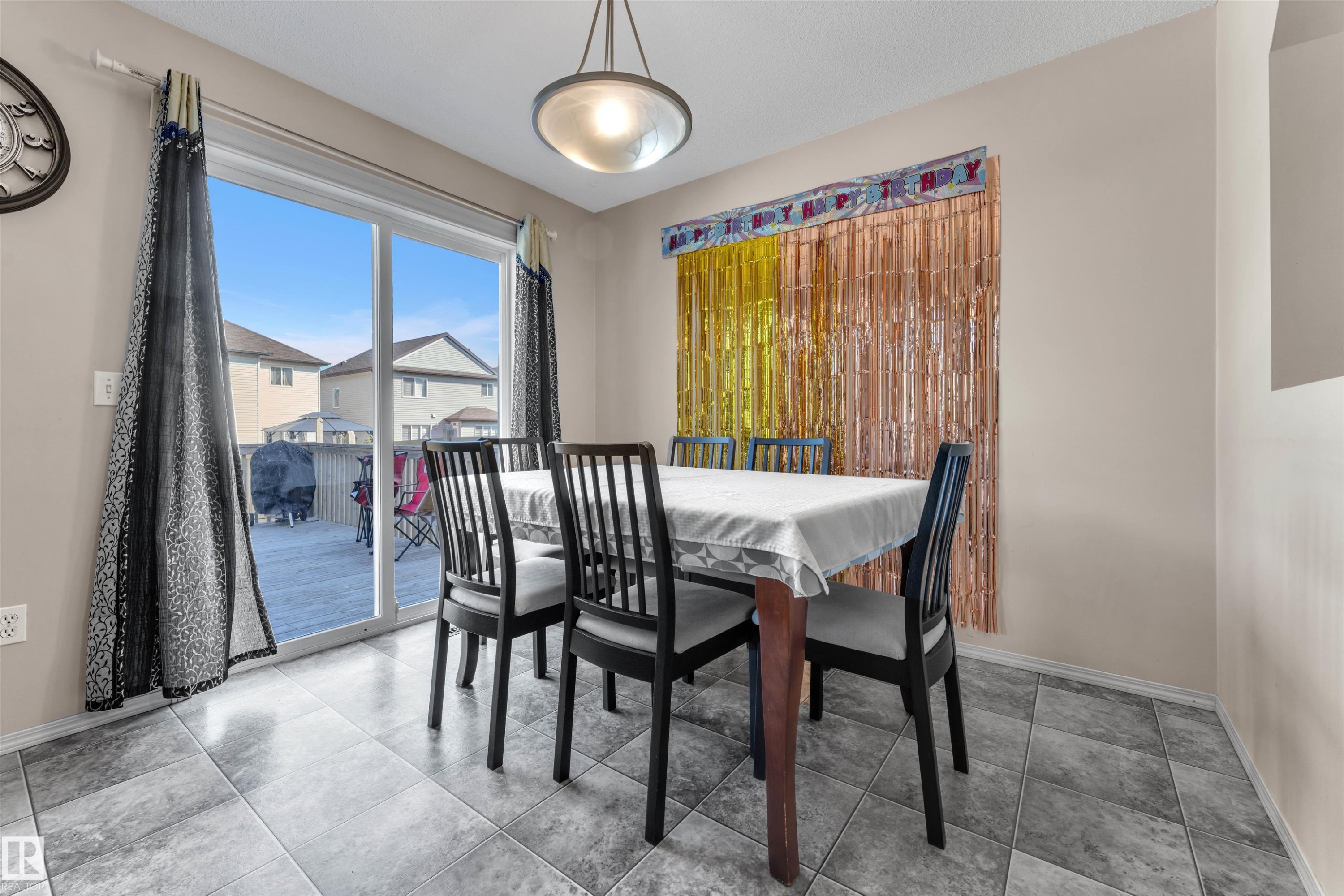 Dining space featuring light tile patterned floors - 6152 13 Avenue, Edmonton, AB - Indoor Photo Showing Dining Room