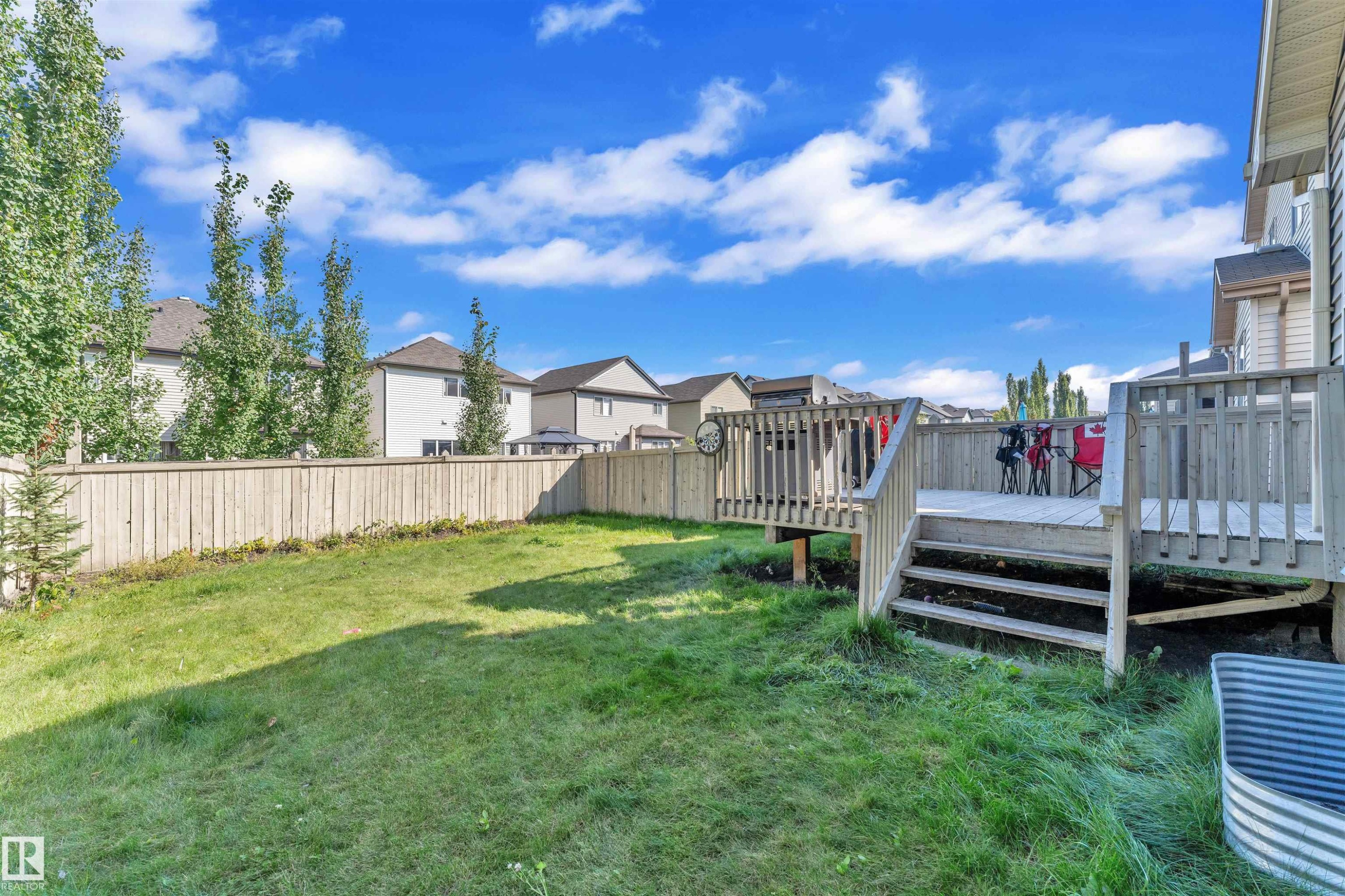 Fenced backyard featuring a deck and a residential view - 6152 13 Avenue, Edmonton, AB - Outdoor