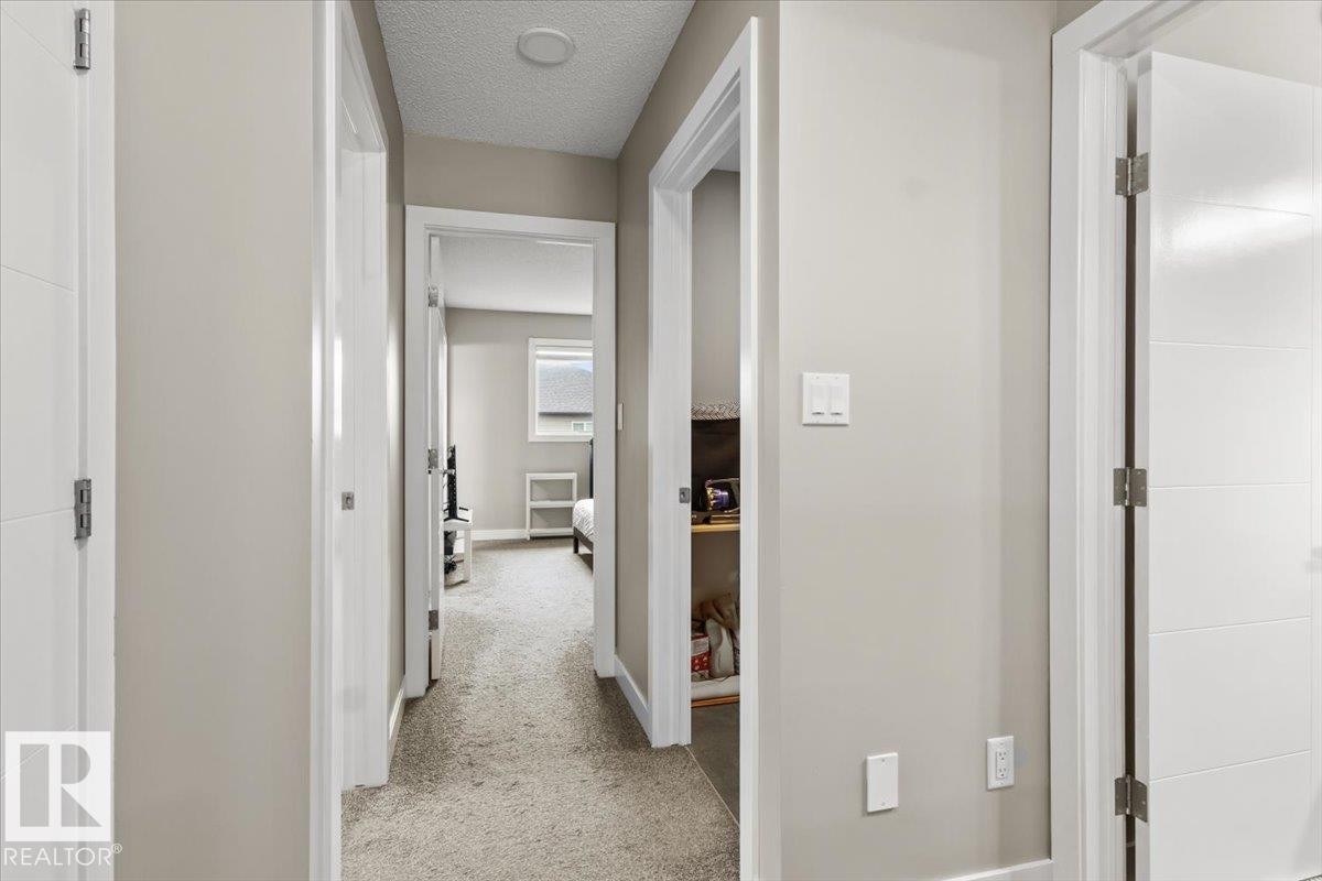 Hallway featuring light neutral wall paint, white trim, recessed ceiling lighting, and carpet flooring - 236 39 Avenue, Edmonton, AB - Indoor Photo Showing Other Room