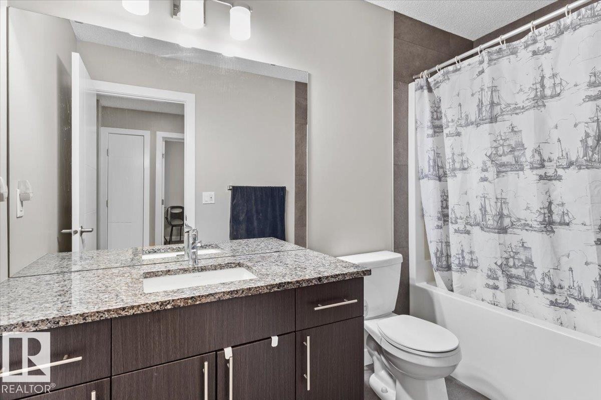 Bathroom featuring a dark wood-finish vanity with a granite countertop and an integrated sink - 236 39 Avenue, Edmonton, AB - Indoor Photo Showing Bathroom
