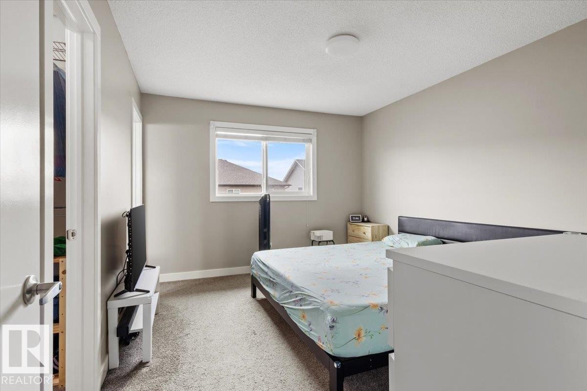 Carpeted bedroom with a window featuring white trim - 236 39 Avenue, Edmonton, AB - Indoor Photo Showing Bedroom