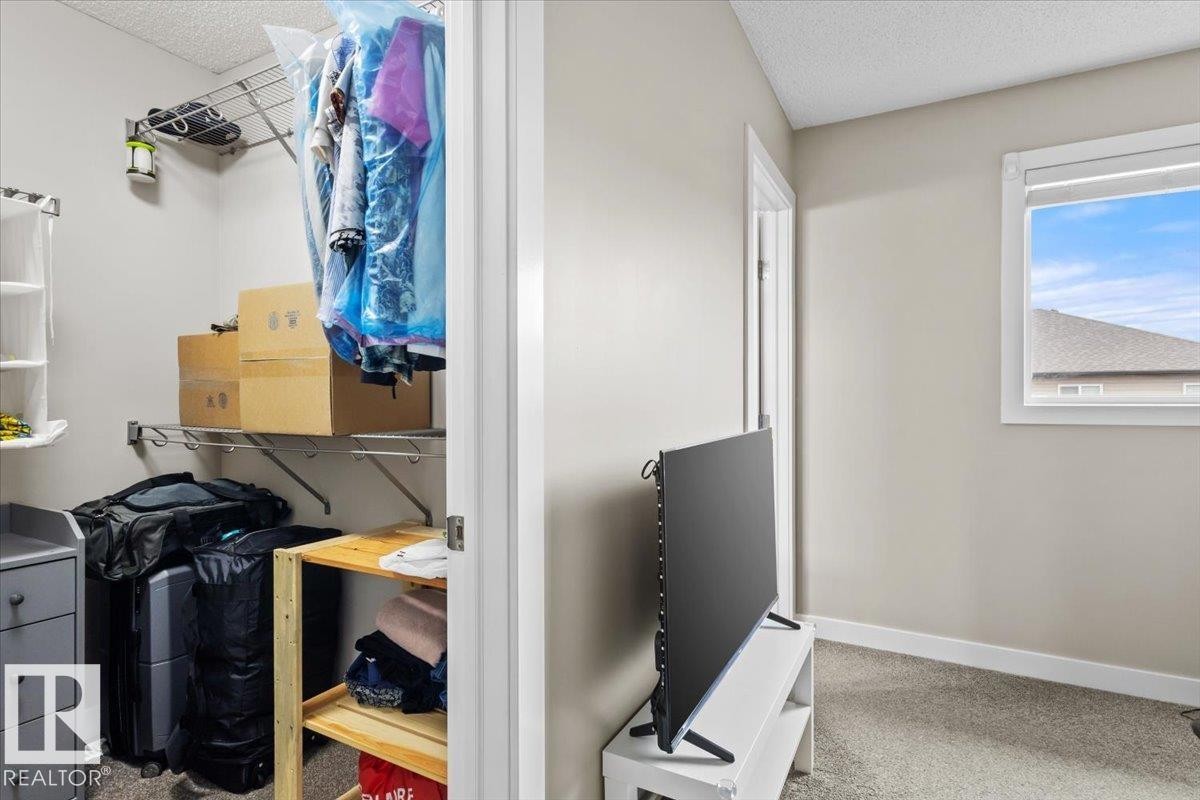 Walk-in closet featuring metal shelving and hanging rods - 236 39 Avenue, Edmonton, AB - Indoor