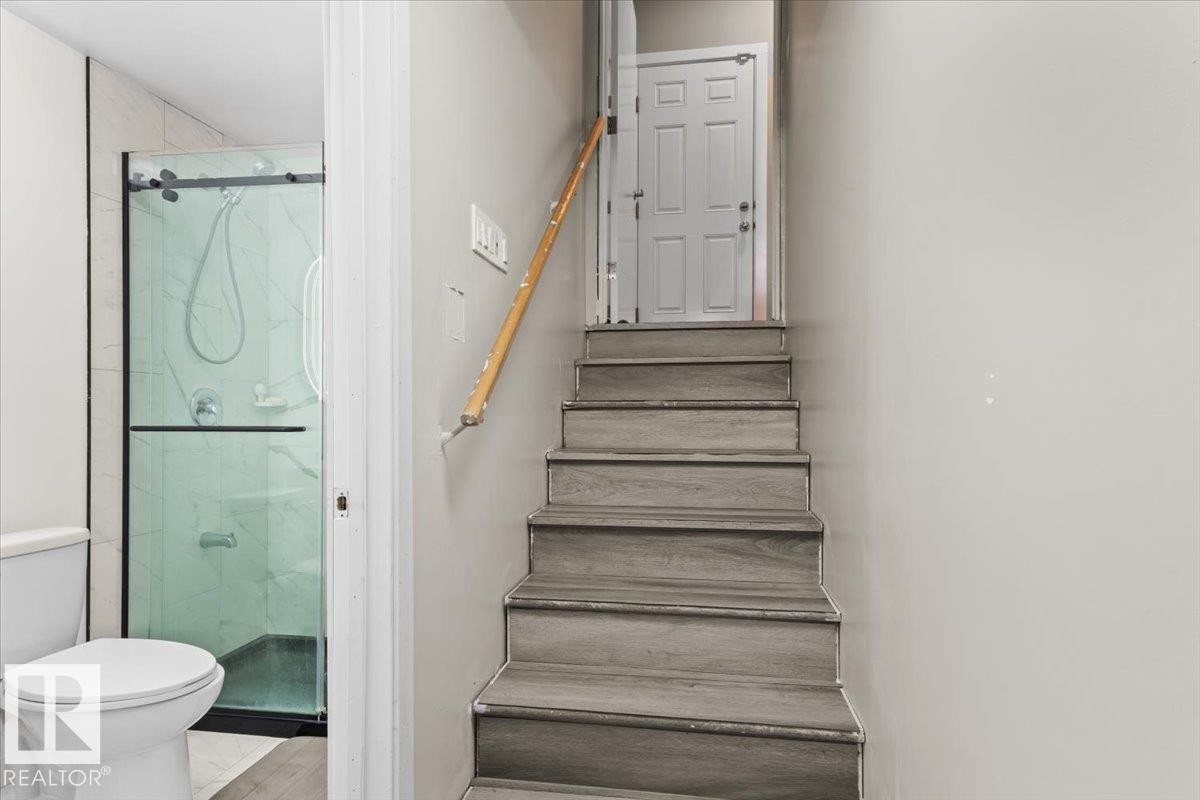 Staircase with wood-finish treads and a light wood handrail - 236 39 Avenue, Edmonton, AB - Indoor