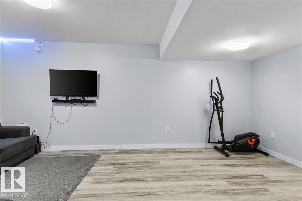 Spacious room featuring light-toned walls, wood-finish flooring, and recessed ceiling lighting - 236 39 Avenue, Edmonton, AB - Indoor Photo Showing Other Room