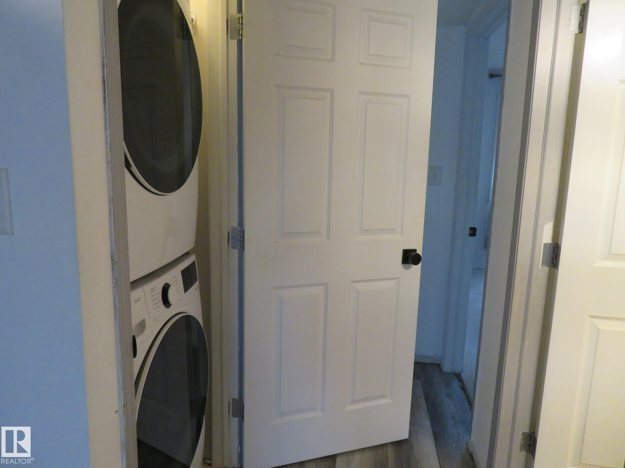 Dedicated laundry area featuring a stacked washer and dryer unit - 2945 26 Street, Edmonton, AB - Indoor Photo Showing Laundry Room
