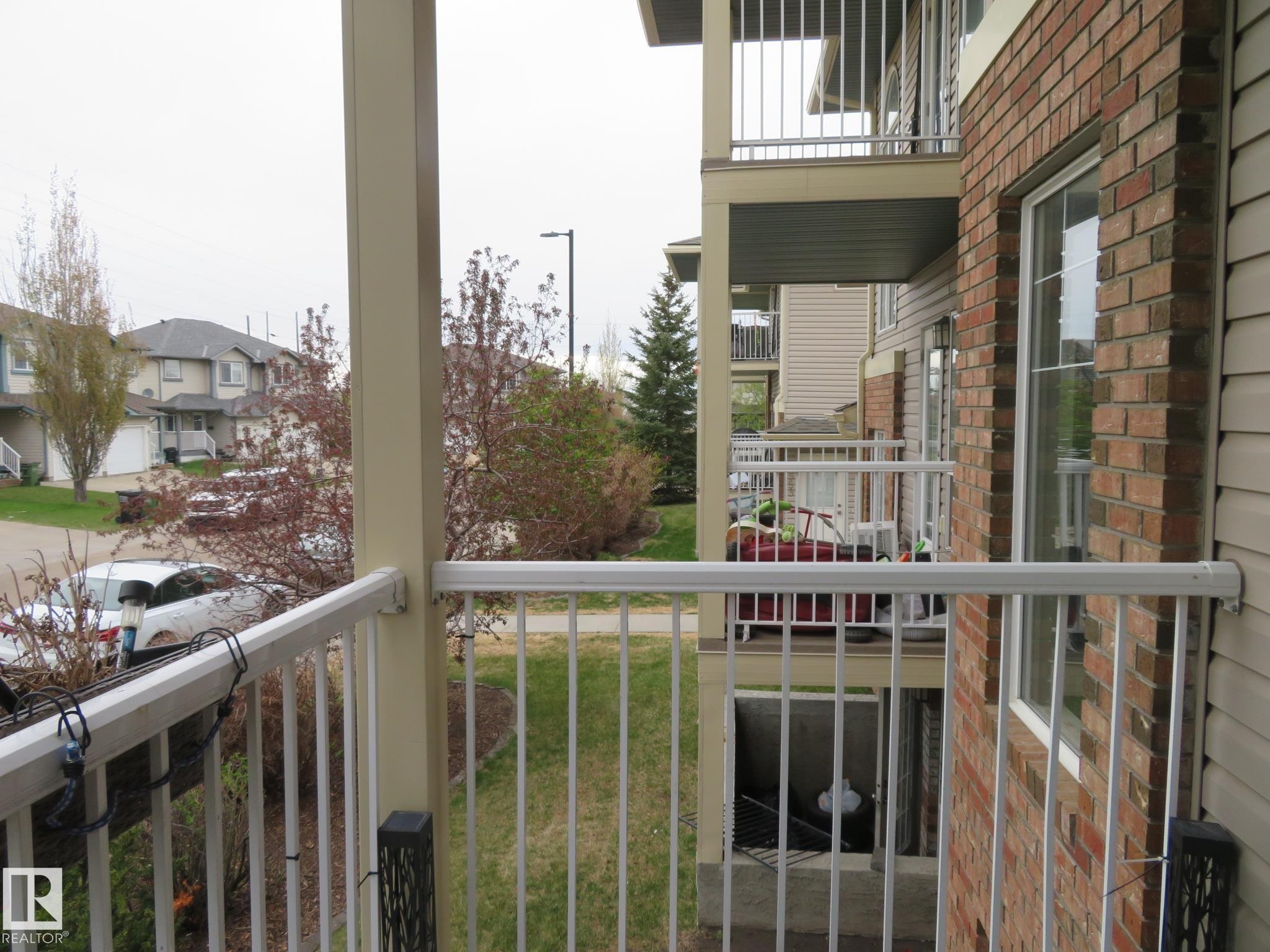 Private balcony featuring white metal railings and a beige support pillar - 2945 26 Street, Edmonton, AB - Outdoor With Balcony