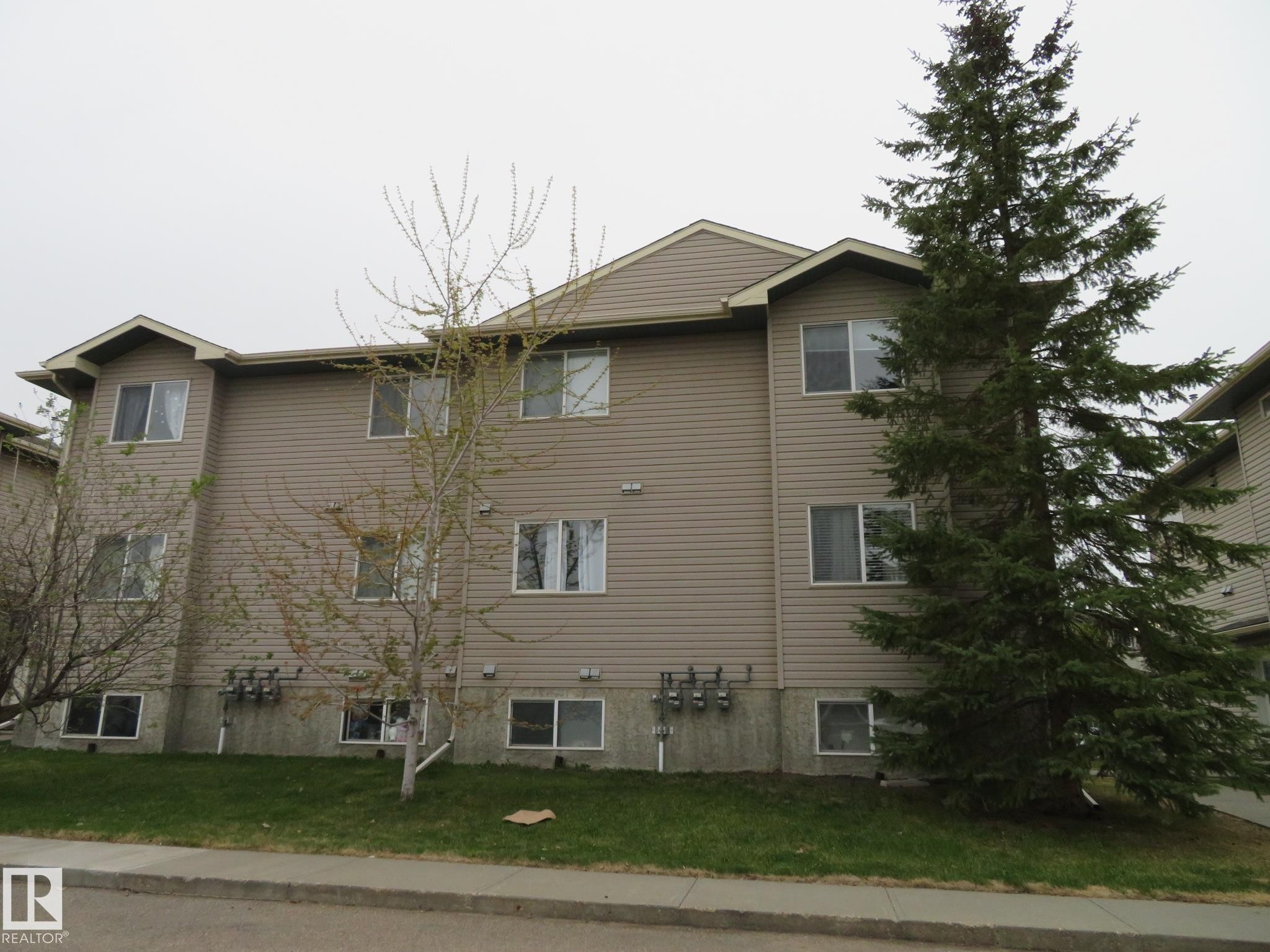 Three-story building with tan horizontal siding - 2945 26 Street, Edmonton, AB - Outdoor