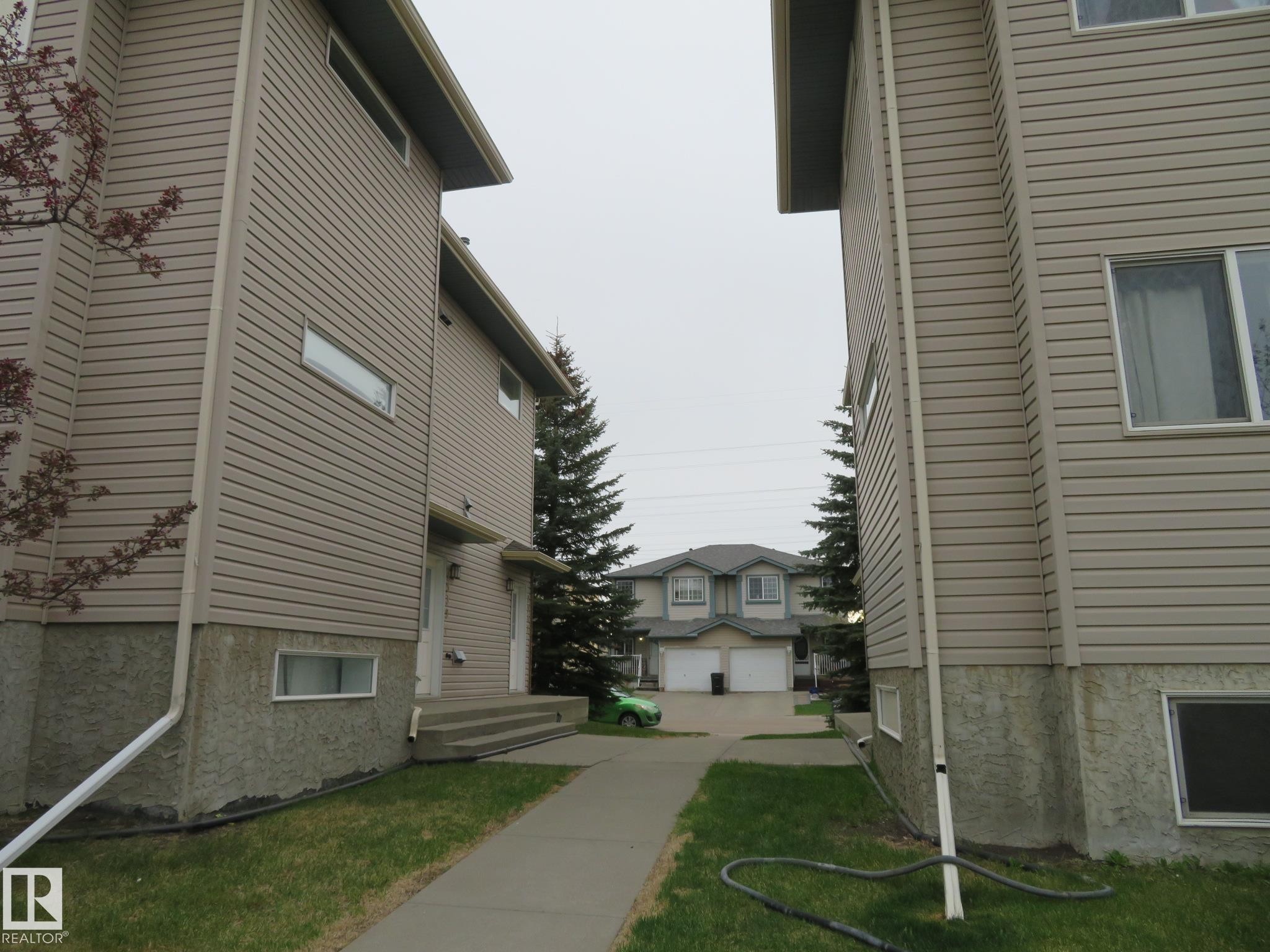 Two-story structures featuring horizontal siding and stucco foundations - 2945 26 Street, Edmonton, AB - Outdoor