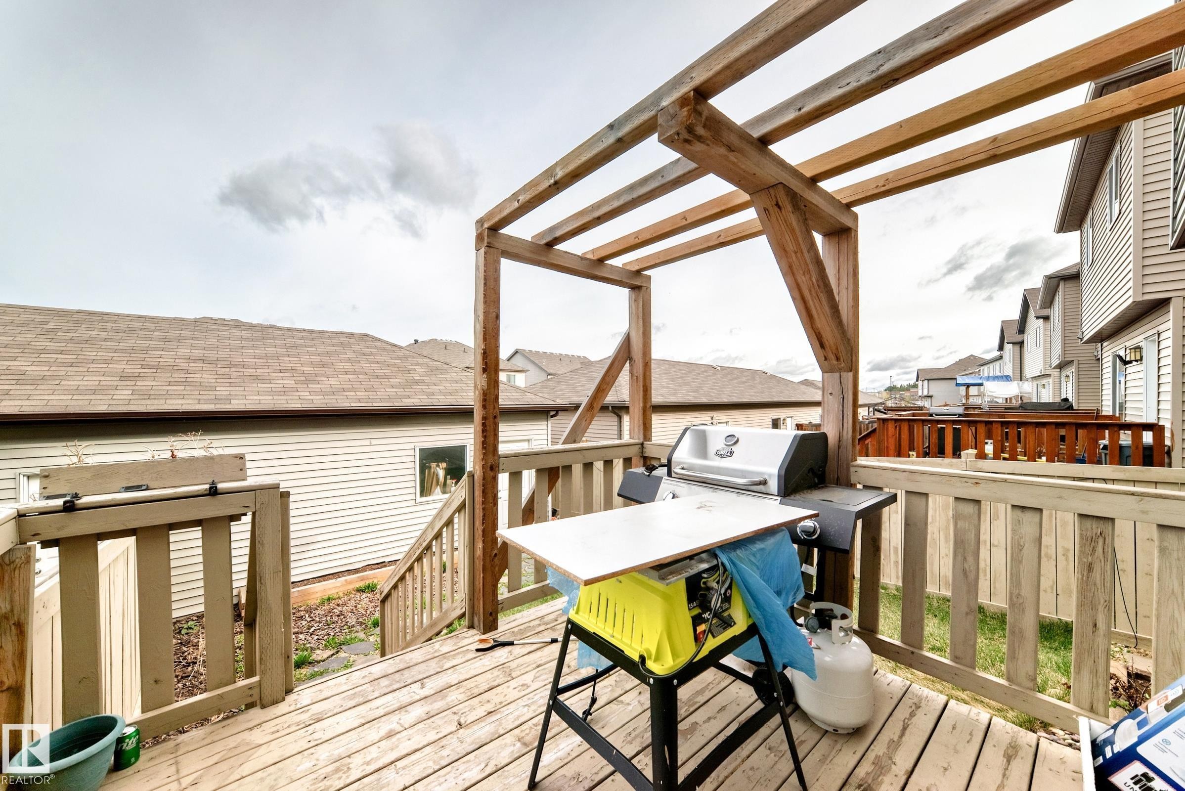 Spacious wood deck featuring a pergola, wood railing, and stairs providing access to the yard - 328 Watt Boulevard, Edmonton, AB - Outdoor With Deck Patio Veranda With Exterior