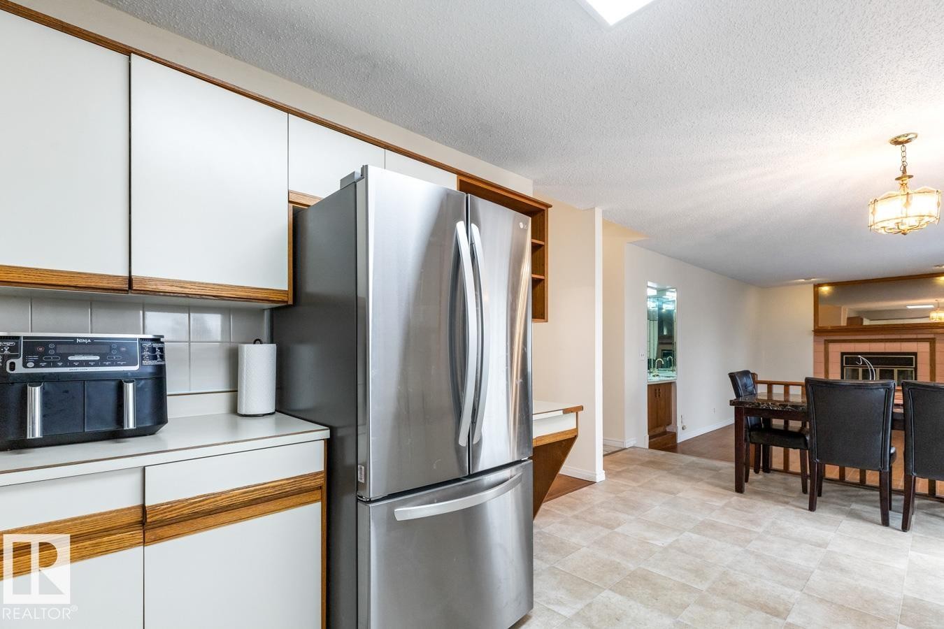 Stainless steel French door refrigerator with dual freezer drawers - 4340 33 Street, Edmonton, AB - Indoor Photo Showing Kitchen