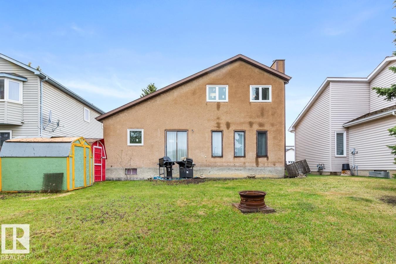 Rear exterior with stucco siding and a prominent chimney - 4340 33 Street, Edmonton, AB - Outdoor With Exterior