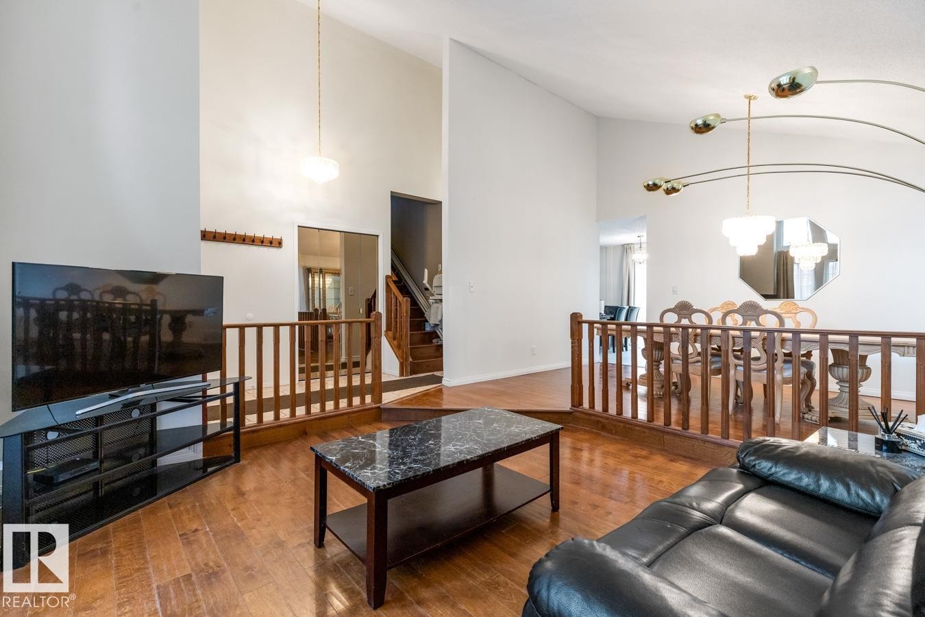 Living area featuring wood-finish flooring and a high vaulted ceiling - 4340 33 Street, Edmonton, AB - Indoor Photo Showing Living Room