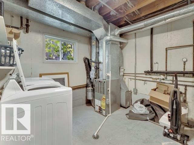 Basement utility area featuring a window, exposed ceiling joists, and a forced-air furnace system - 3602 50Th Ave, Sylvan Lake, AB - Indoor Photo Showing Laundry Room