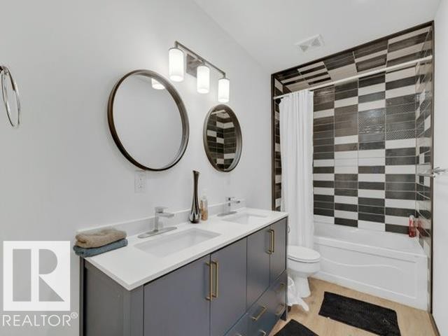 Bathroom featuring a dual vanity with a white countertop and rectangular sinks - 3602 50Th Ave, Sylvan Lake, AB - Indoor Photo Showing Bathroom