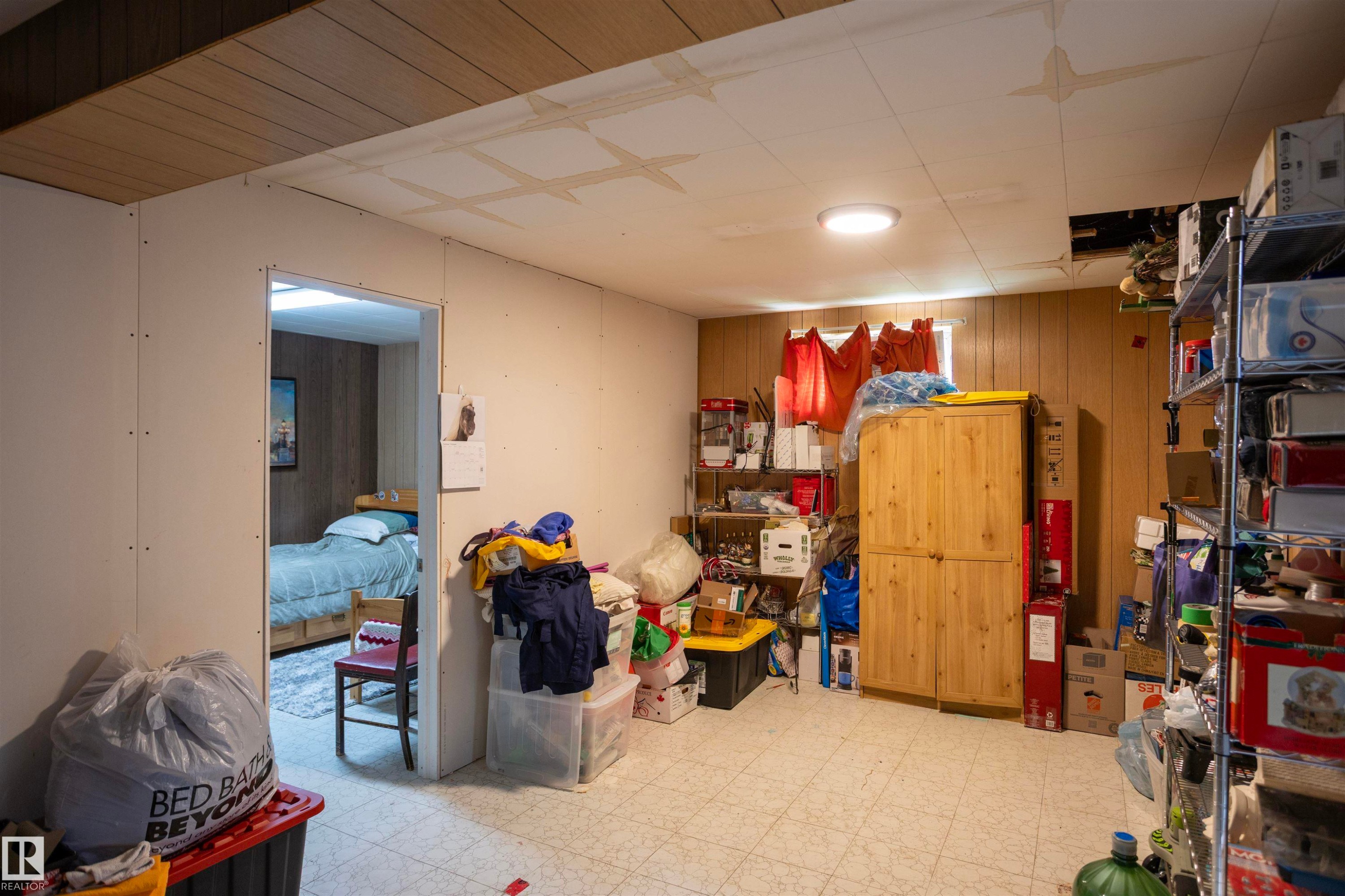 Room featuring vinyl tile flooring and a partial suspended ceiling - 10428 68 Avenue, Edmonton, AB - Indoor