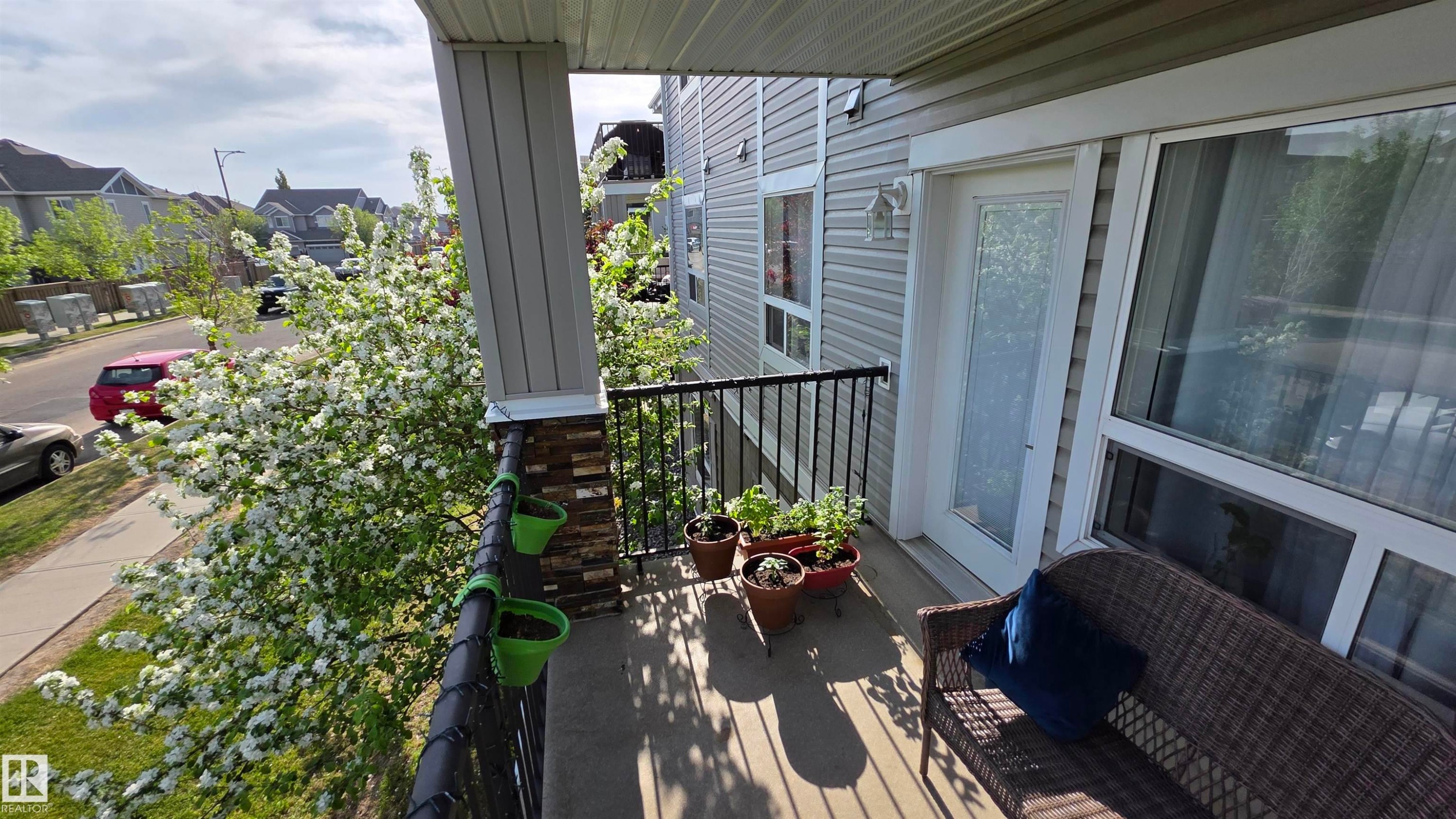 Balcony with wood-finish flooring and black metal railing - 1228 9363 Simpson Drive, Edmonton, AB - Outdoor With Exterior