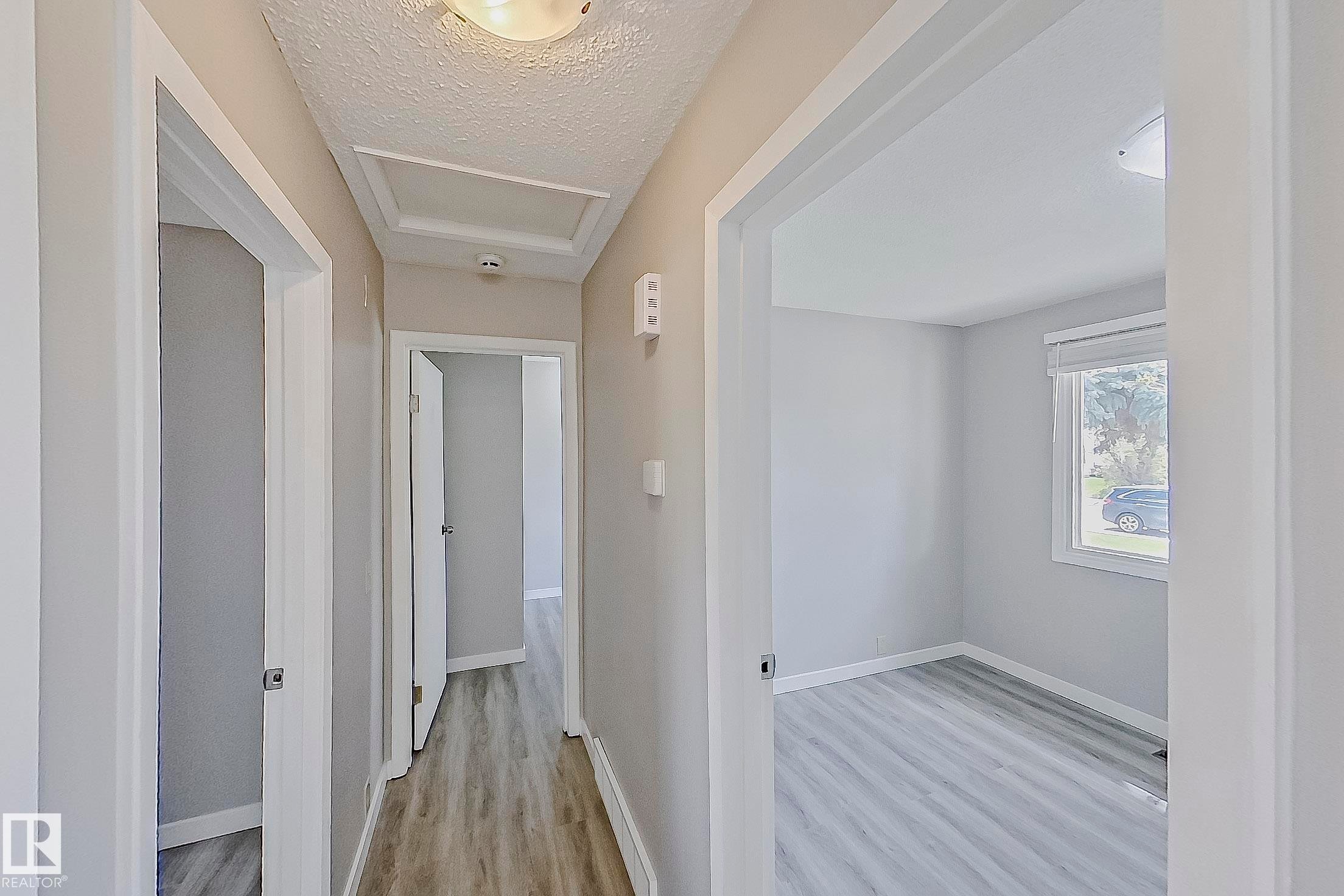 Main floor hallway to 3 bedrooms and bathroom with new vinyl plank flooring. - 11436 161 Avenue, Edmonton, AB - Indoor Photo Showing Other Room