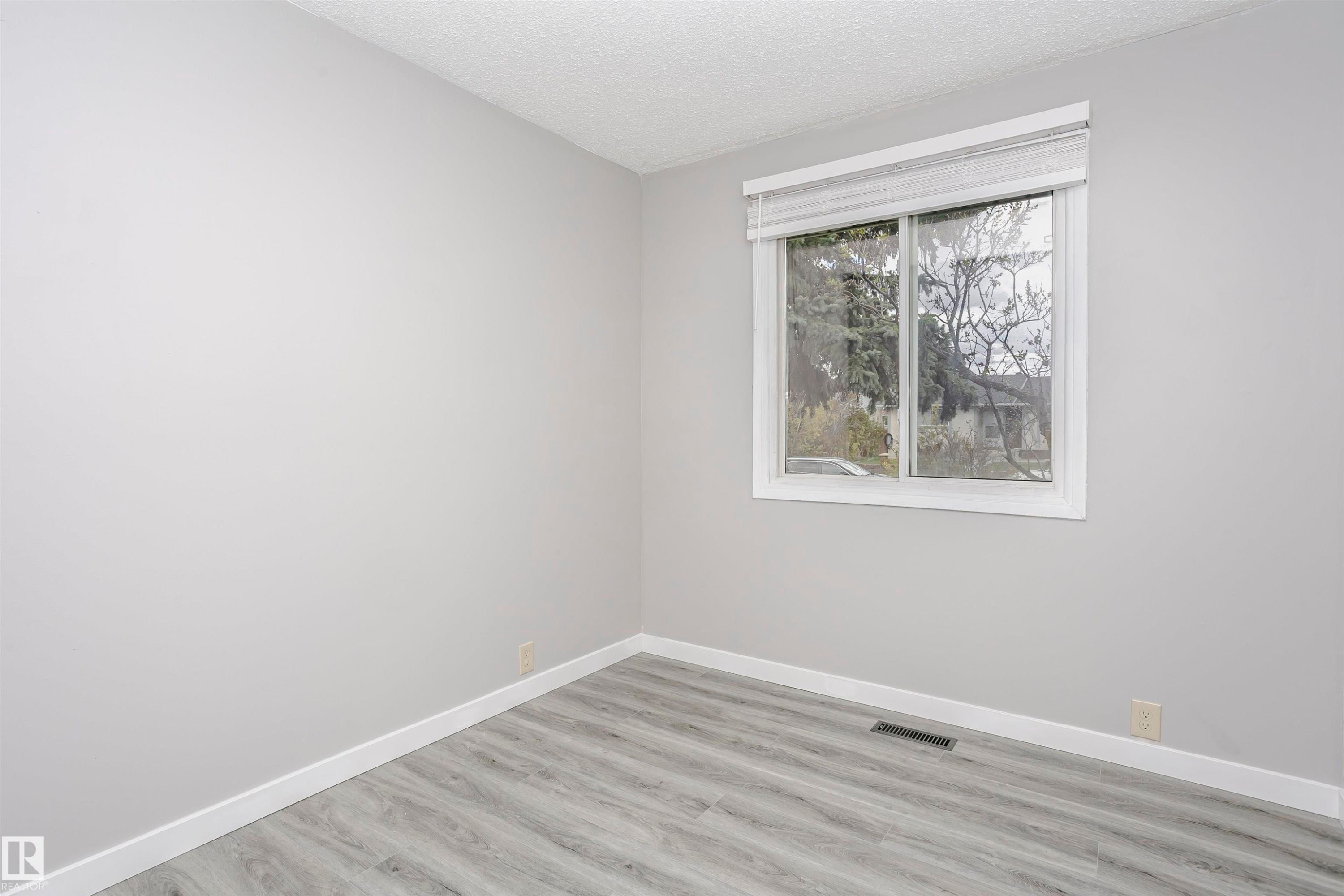 Bedroom 2 on main floor with vinly plank flooring. - 11436 161 Avenue, Edmonton, AB - Indoor Photo Showing Other Room