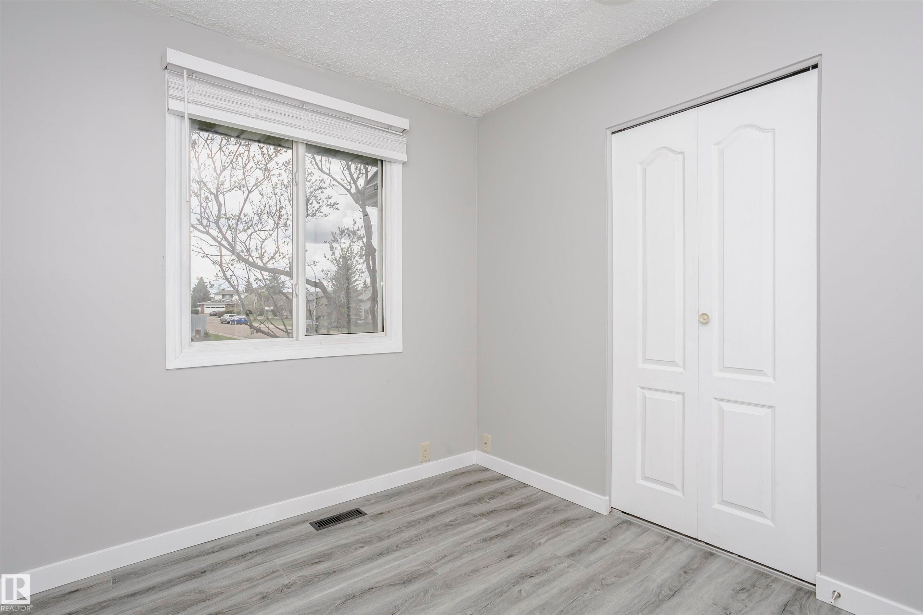 Bedroom 2 on main floor with vinly plank flooring. - 11436 161 Avenue, Edmonton, AB - Indoor Photo Showing Other Room