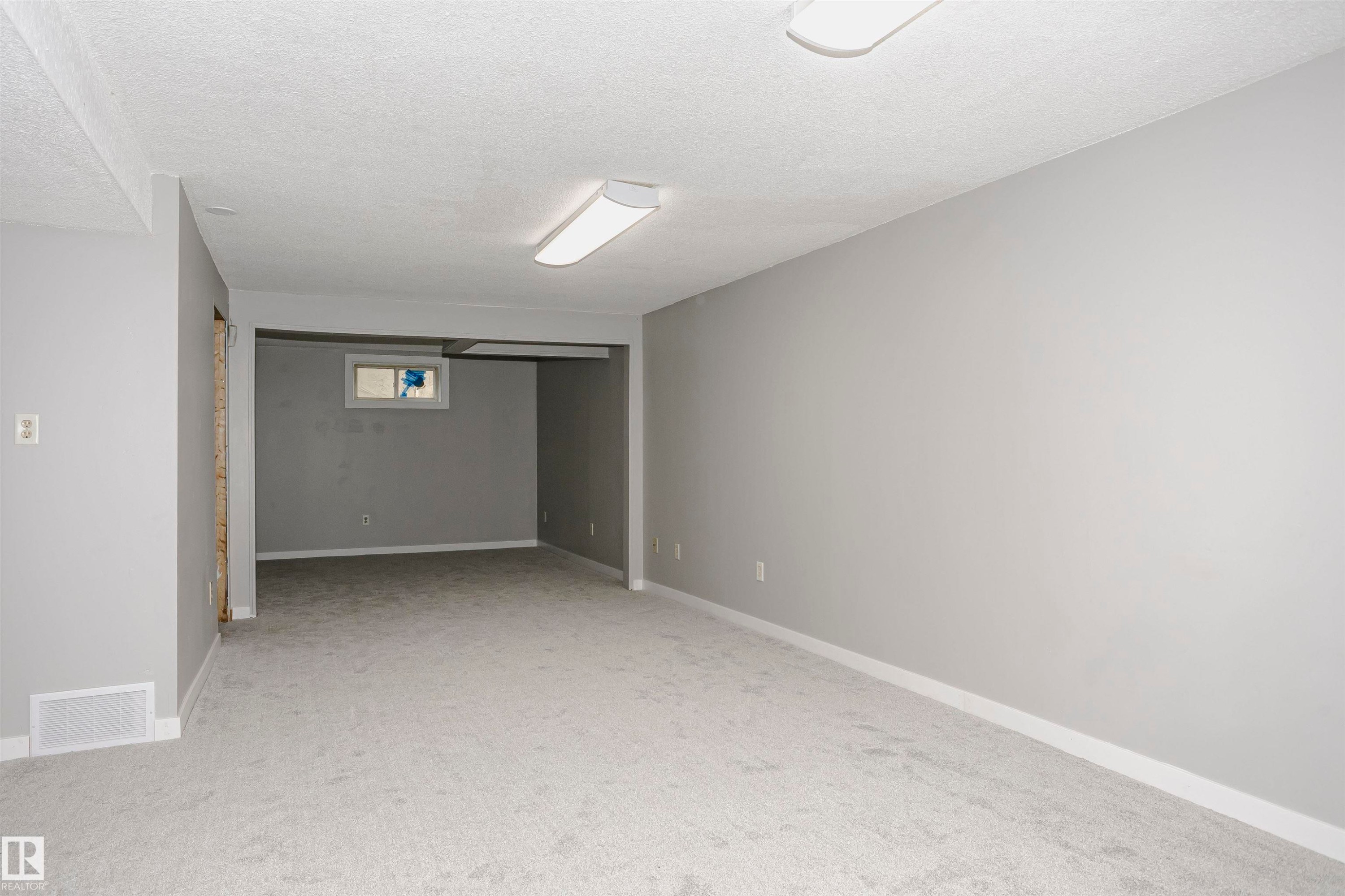 Huge family room with new plush carpet. Lots of room to add bedroom 5 at the end with a window if desired. - 11436 161 Avenue, Edmonton, AB - Indoor Photo Showing Other Room