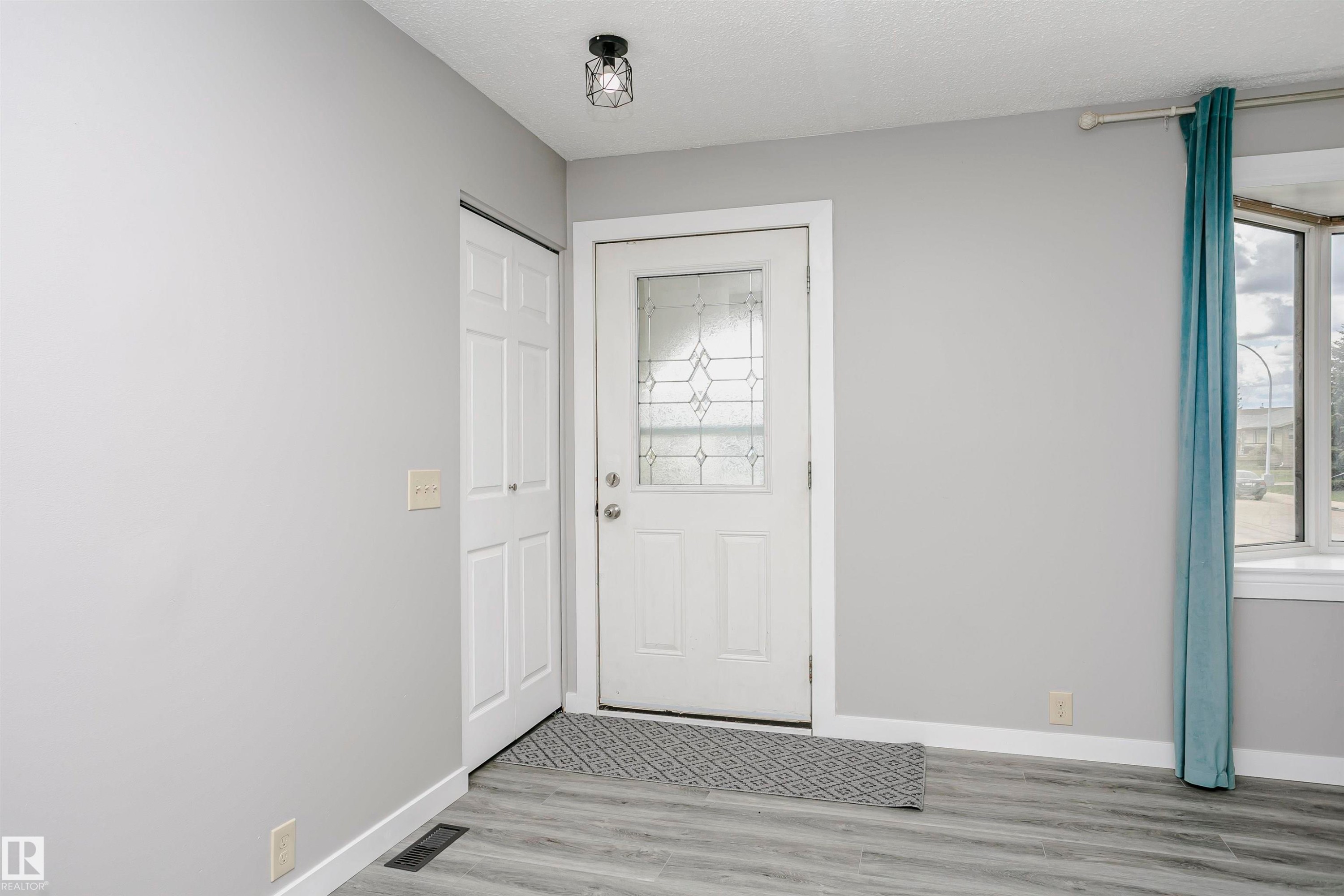Beautiful new vinyl plank flooring in front entry and throughout main floor. Tile in kitchen and bathrooms. Freshly painted throughout and new lighting. - 11436 161 Avenue, Edmonton, AB - Indoor Photo Showing Other Room