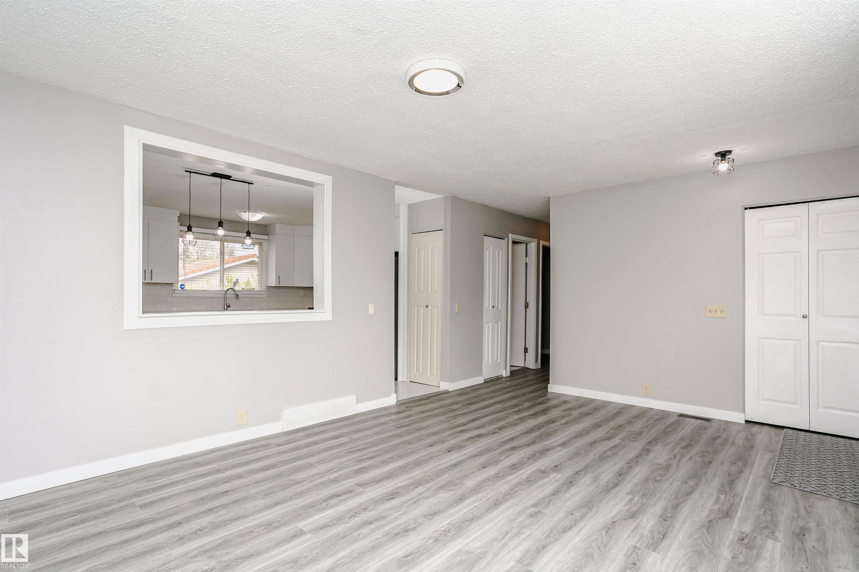 Convenient cut through window from living room into kitchen and dinette area adds natural light. - 11436 161 Avenue, Edmonton, AB - Indoor Photo Showing Other Room