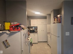 Kitchen featuring white cabinetry and tile flooring -
