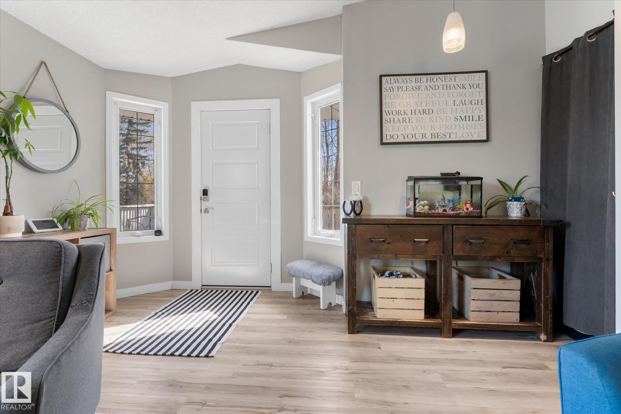 Entry foyer featuring light wood-finish flooring and a contemporary white panel door - 4759 48 Street, Onoway, AB - Indoor Photo Showing Other Room